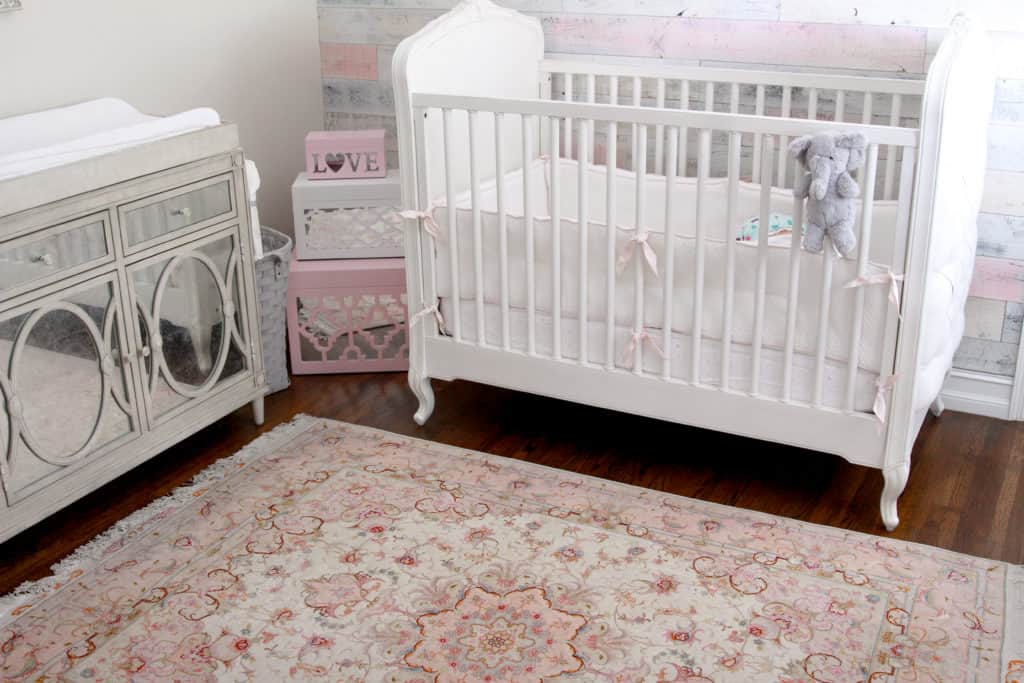 Pink and White Rustic Chic Nursery Decor - including an antique rug, Restoration Hardware Baby crib and dress, and a wood wall