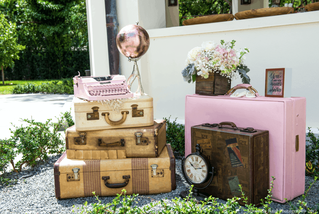 Some of the vintage travel details for my You Are Our Greatest Adventure baby shower for my little girl - decorated with antique luggages, globe, typewriter and flowers