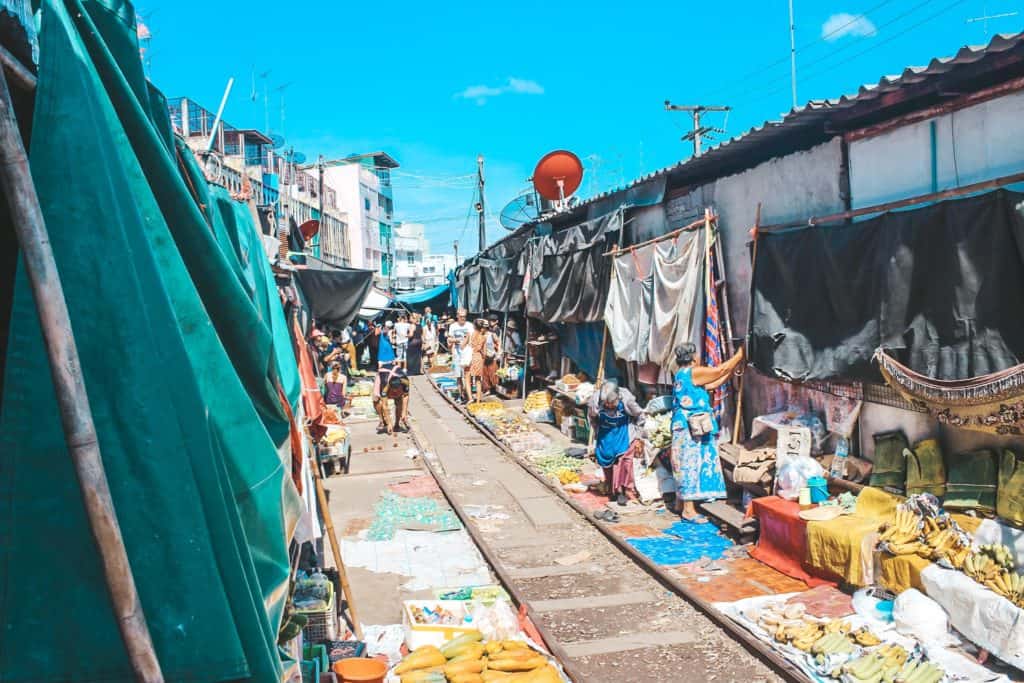 The railway market in Thailand... the train goes right past all the vendors. When the train is coming they pull back their canopies to make space for the train. Tour of the Railway Market and Floating Market from Bangkok, Thailand. #bangkok #thailand #railwaymarket #floatingmarket