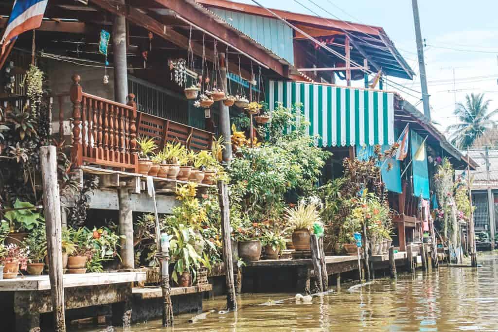 Some of the houses on the floating market in Thailand... an entire market on the waterway and the vendors are each on their little boats. Tour of the Railway Market and Floating Market from Bangkok, Thailand. #bangkok #thailand #railwaymarket #floatingmarket