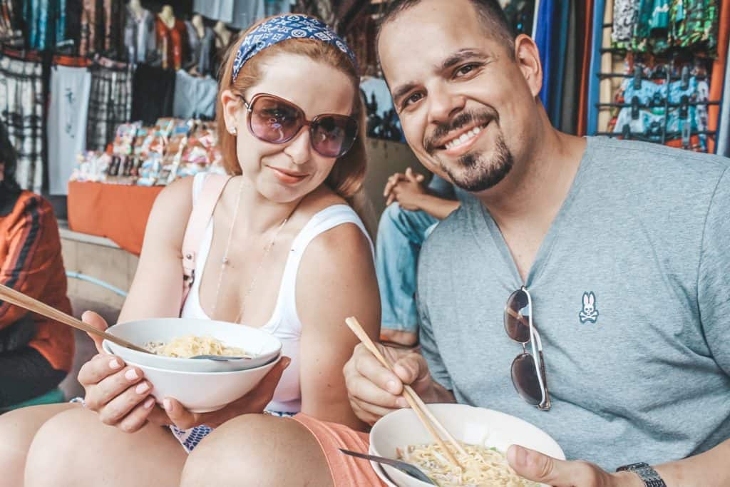 Enjoying a bowl of noodles from the famous older lady that has been serving noodles from her boat for over 50 years at the floating market in Thailand. It is an entire market on the waterway and the vendors are each on their little boats. Tour of the Railway Market and Floating Market from Bangkok, Thailand. #bangkok #thailand #railwaymarket #floatingmarket