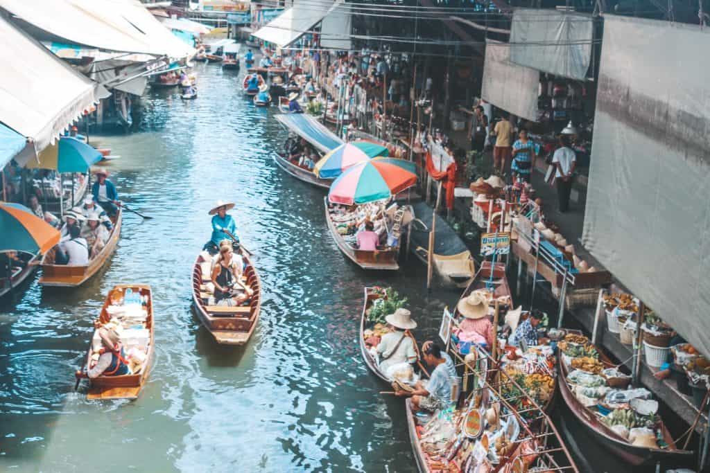 The floating market in Thailand is an entire market on the waterway and the vendors are each on their little boats. Tour of the Railway Market and Floating Market from Bangkok, Thailand. #bangkok #thailand #railwaymarket #floatingmarket