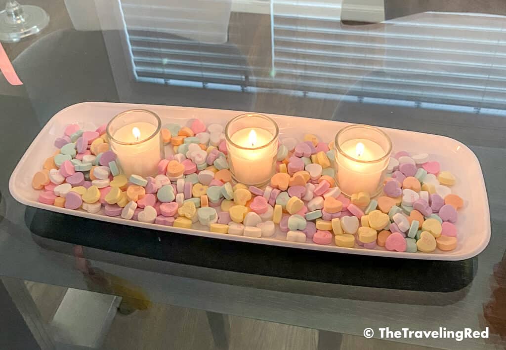 Valentine's Day Home Decor Dining Room Table Decor for a Valentines Day party using plastic trays, glass vases, sweetheart candies, votive candles & fresh roses - #valentinesday #valentinesdaydecor #homedecor #tabledecor #valentinesdayhomedecor