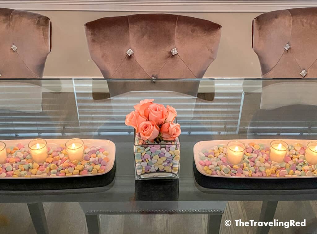Valentine's Day Home Decor Dining Room Table Decor for a Valentines Day party using plastic trays, glass vases, sweetheart candies, votive candles & fresh roses - #valentinesday #valentinesdaydecor #homedecor #tabledecor #valentinesdayhomedecor