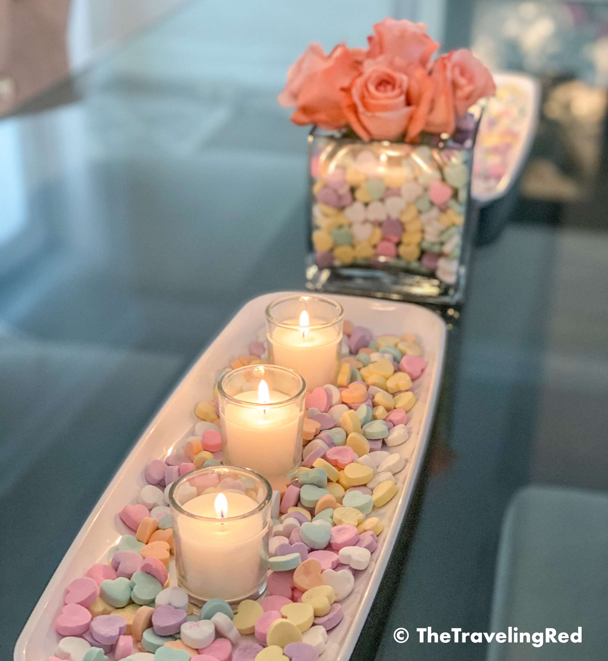 Valentine's Day Home Decor Dining Room Table Decor for a Valentines Day party using plastic trays, glass vases, sweetheart candies, votive candles & fresh roses - #valentinesday #valentinesdaydecor #homedecor #tabledecor #valentinesdayhomedecor