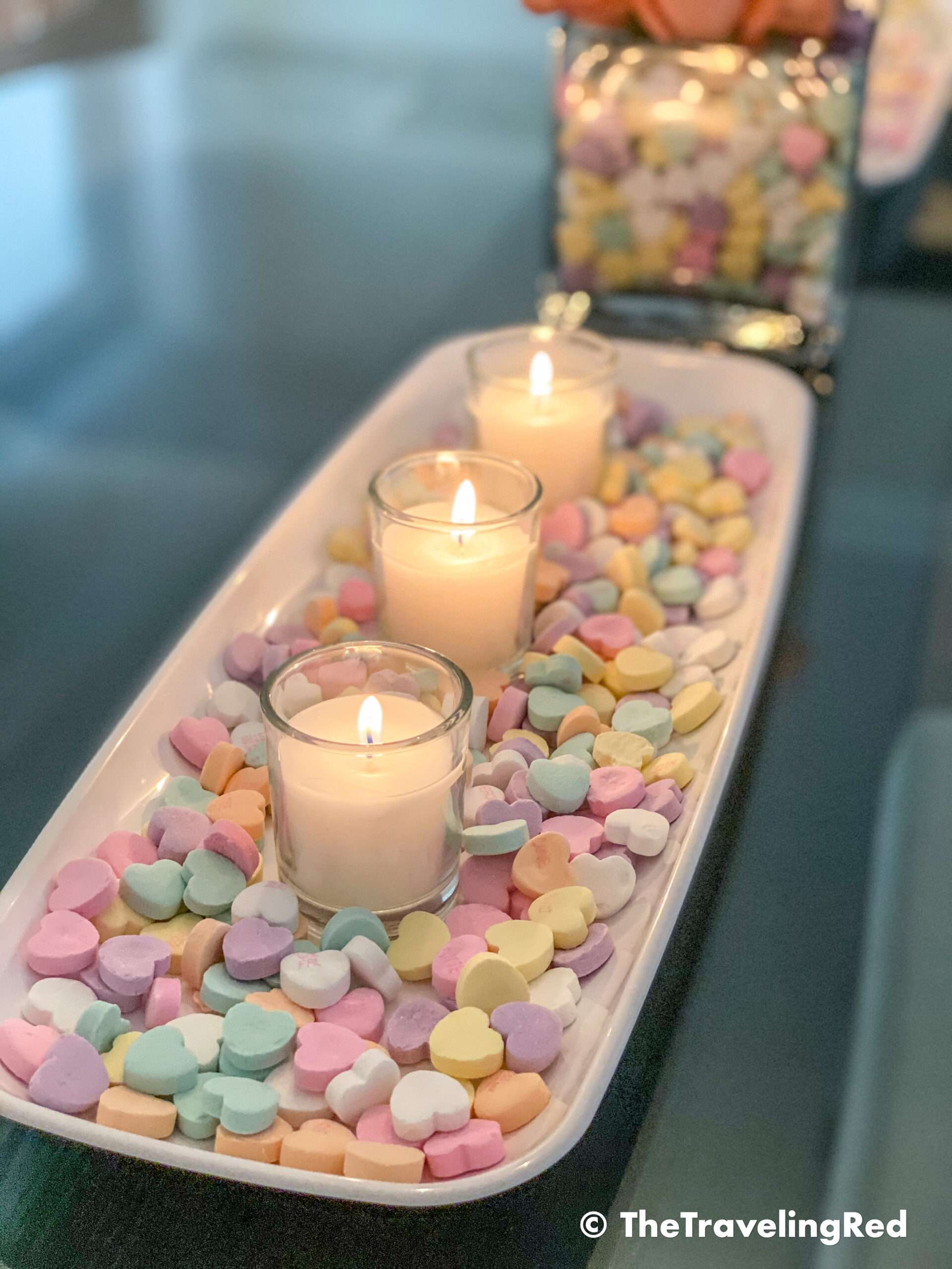 Valentine's Day Home Decor Dining Room Table Decor for a Valentines Day party using plastic trays, glass vases, sweetheart candies, votive candles & fresh roses - #valentinesday #valentinesdaydecor #homedecor #tabledecor #valentinesdayhomedecor