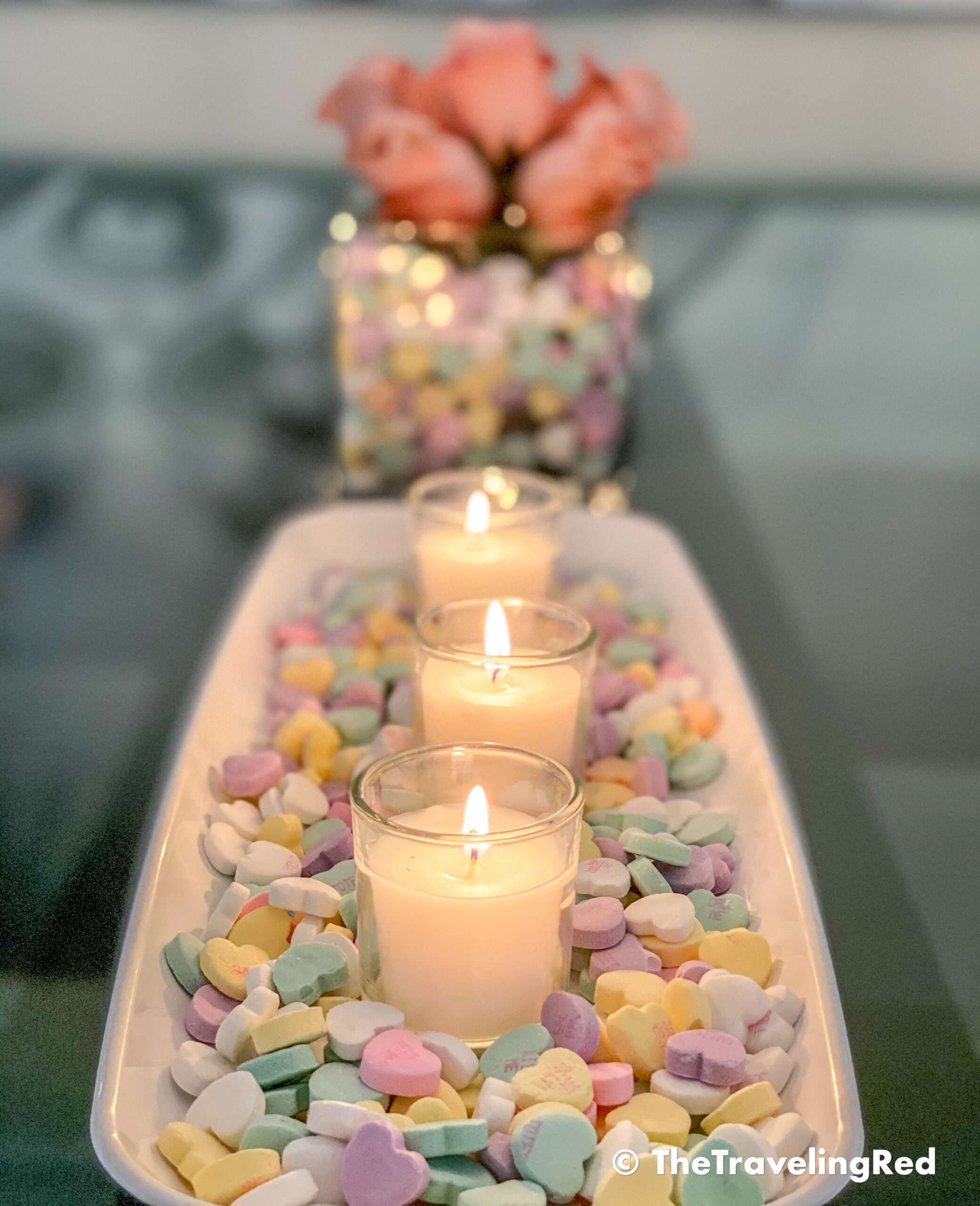 Valentine's Day Home Decor Dining Room Table Decor for a Valentines Day party using plastic trays, glass vases, sweetheart candies, votive candles & fresh roses - #valentinesday #valentinesdaydecor #homedecor #tabledecor #valentinesdayhomedecor