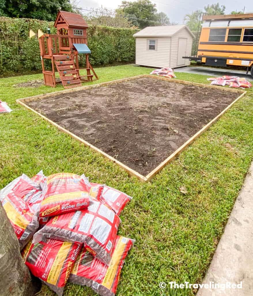 How to build a custom backyard playground with rubber mulch. Step 3 is to add a wood edge to enclose the area. This space will fit our swingset, playhouse, sandbox or any other outdoor toys you plan to include. Perfect little outdoor play space for your kids to enjoy playing outside.