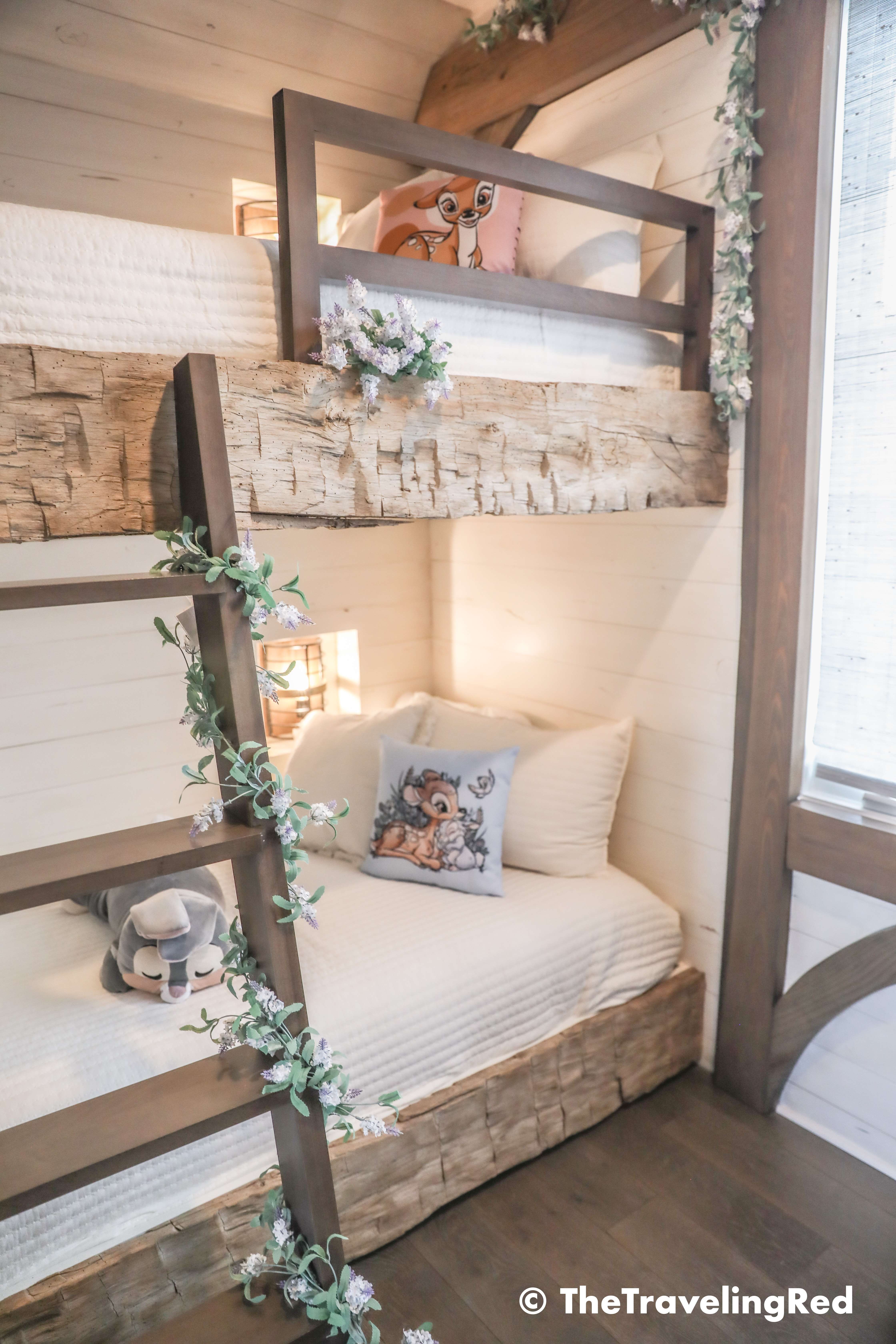 Bambi bunk bed room inside our Disney Golden Oak home. Inspiration for a tiny kids bedroom full of rustic charm and character. Reclaimed wood beams, shiplap, flowers and lanterns fill the room, along with Bambi details.