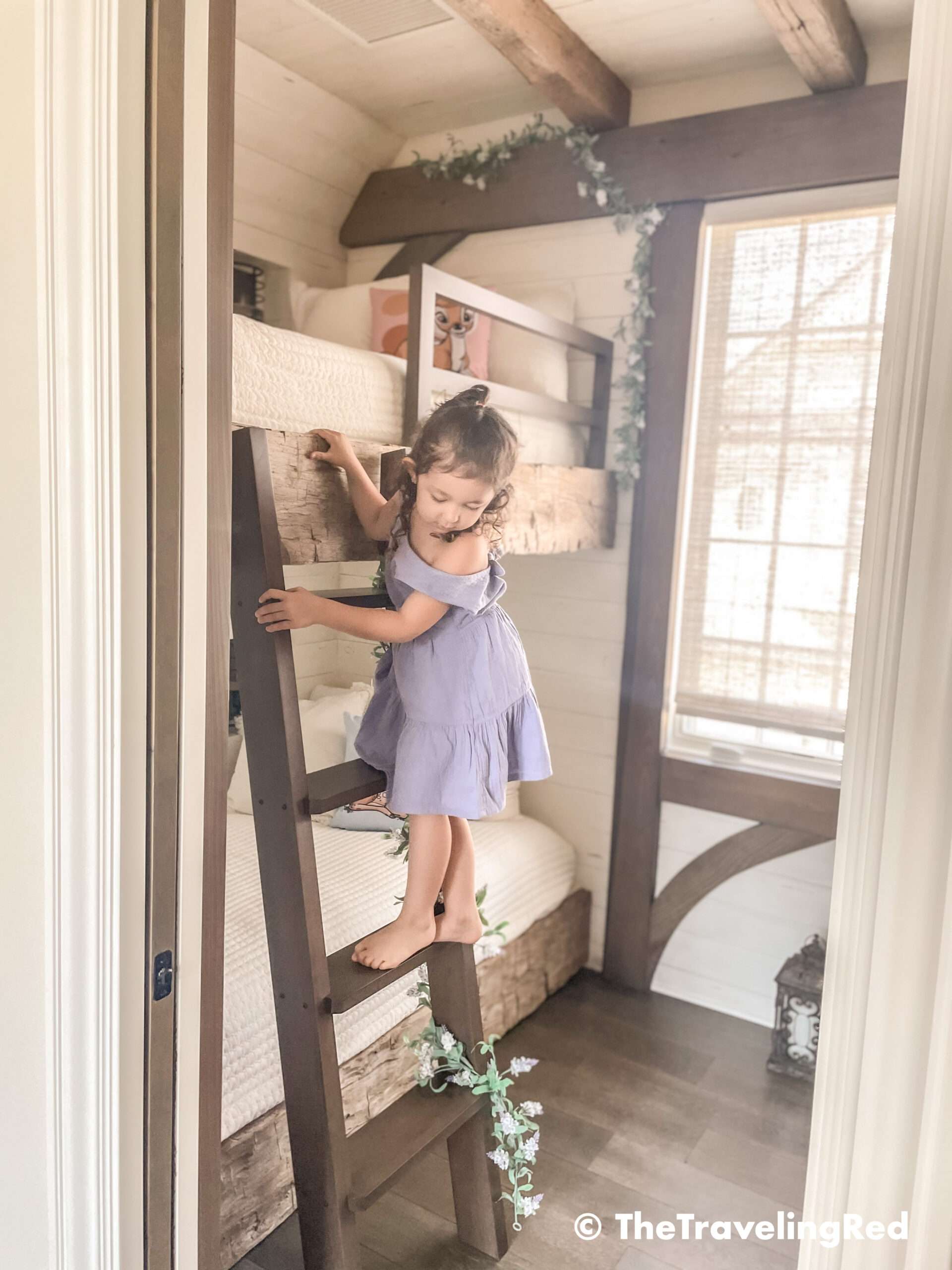 Bambi bunk bed room inside our Disney Golden Oak home. Inspiration for a tiny kids bedroom full of rustic charm and character. Reclaimed wood beams, shiplap, flowers and lanterns fill the room, along with Bambi details.