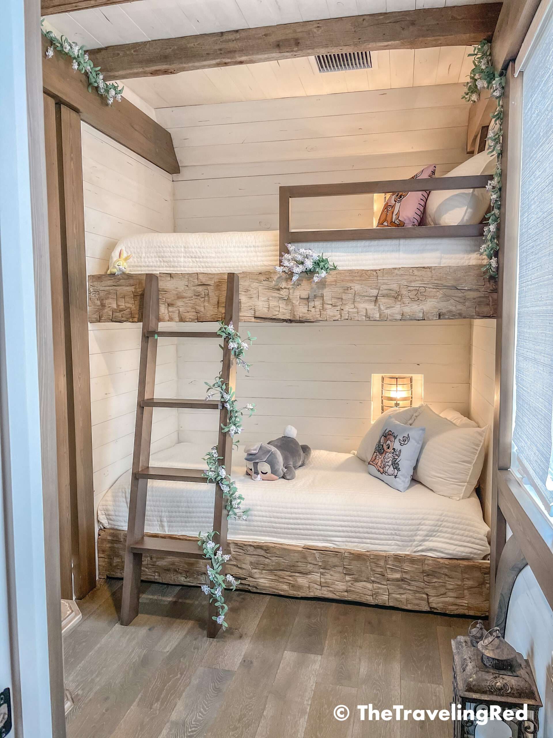 Bambi bunk bed room inside our Disney Golden Oak home. Inspiration for a tiny kids bedroom full of rustic charm and character. Reclaimed wood beams, shiplap, flowers and lanterns fill the room, along with Bambi details.