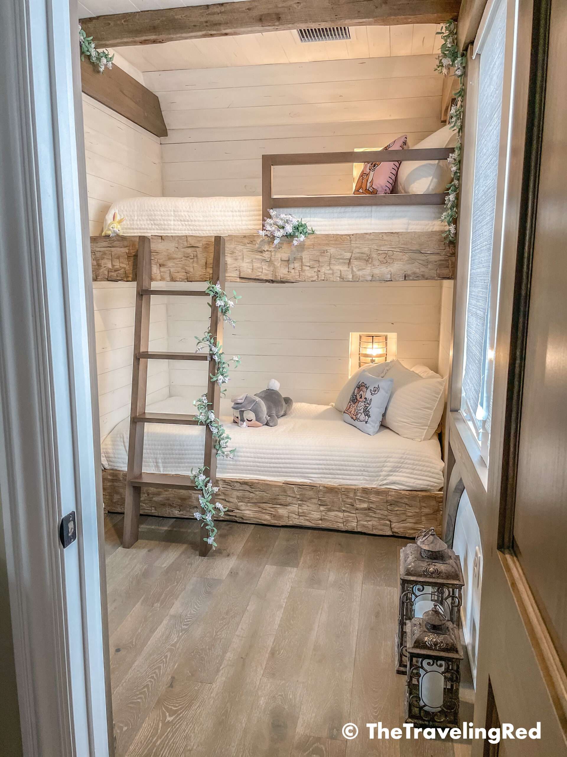 Bambi bunk bed room inside our Disney Golden Oak home. Inspiration for a tiny kids bedroom full of rustic charm and character. Reclaimed wood beams, shiplap, flowers and lanterns fill the room, along with Bambi details.