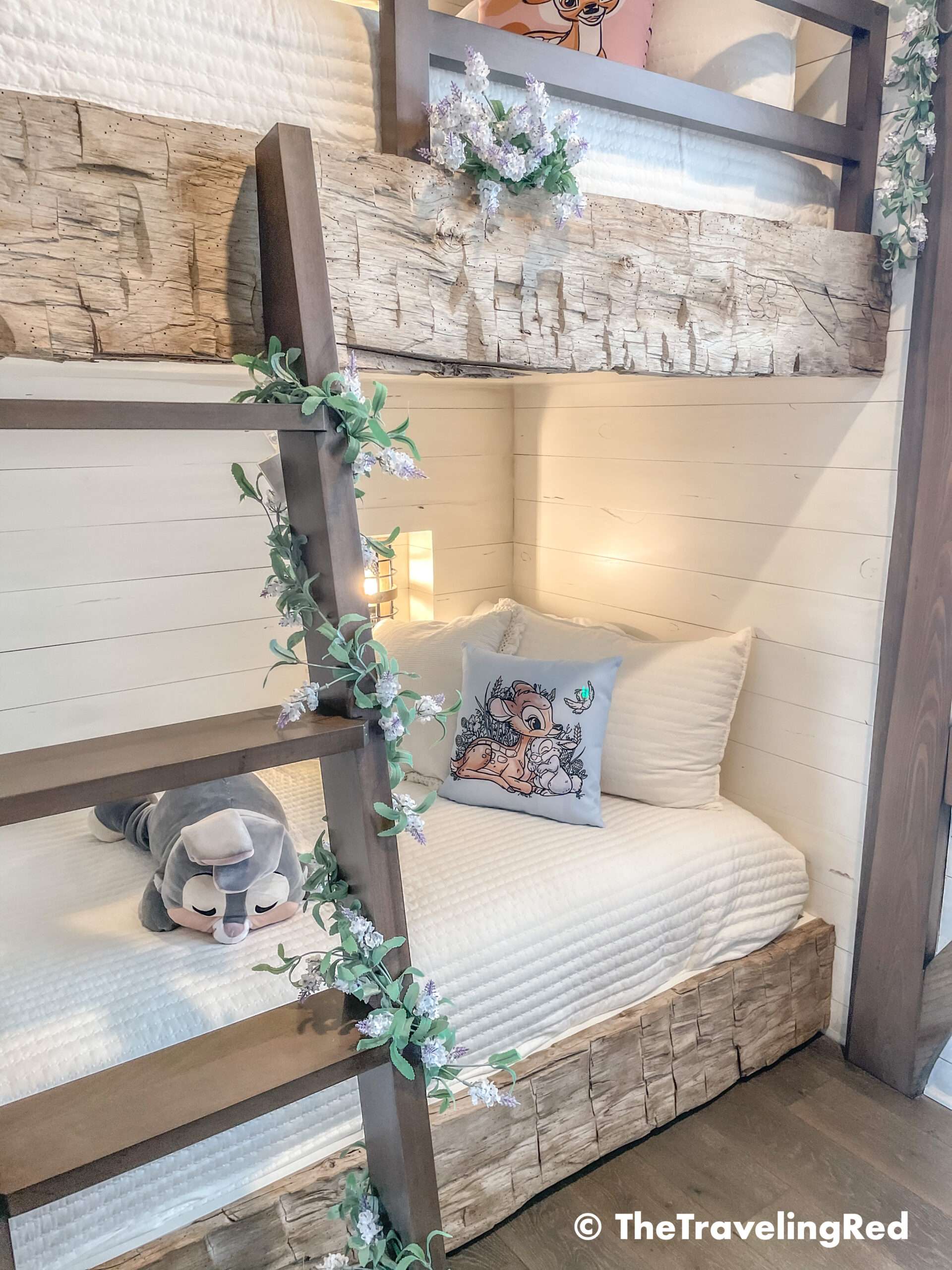 Bambi bunk bed room inside our Disney Golden Oak home. Inspiration for a tiny kids bedroom full of rustic charm and character. Reclaimed wood beams, shiplap, flowers and lanterns fill the room, along with Bambi details.