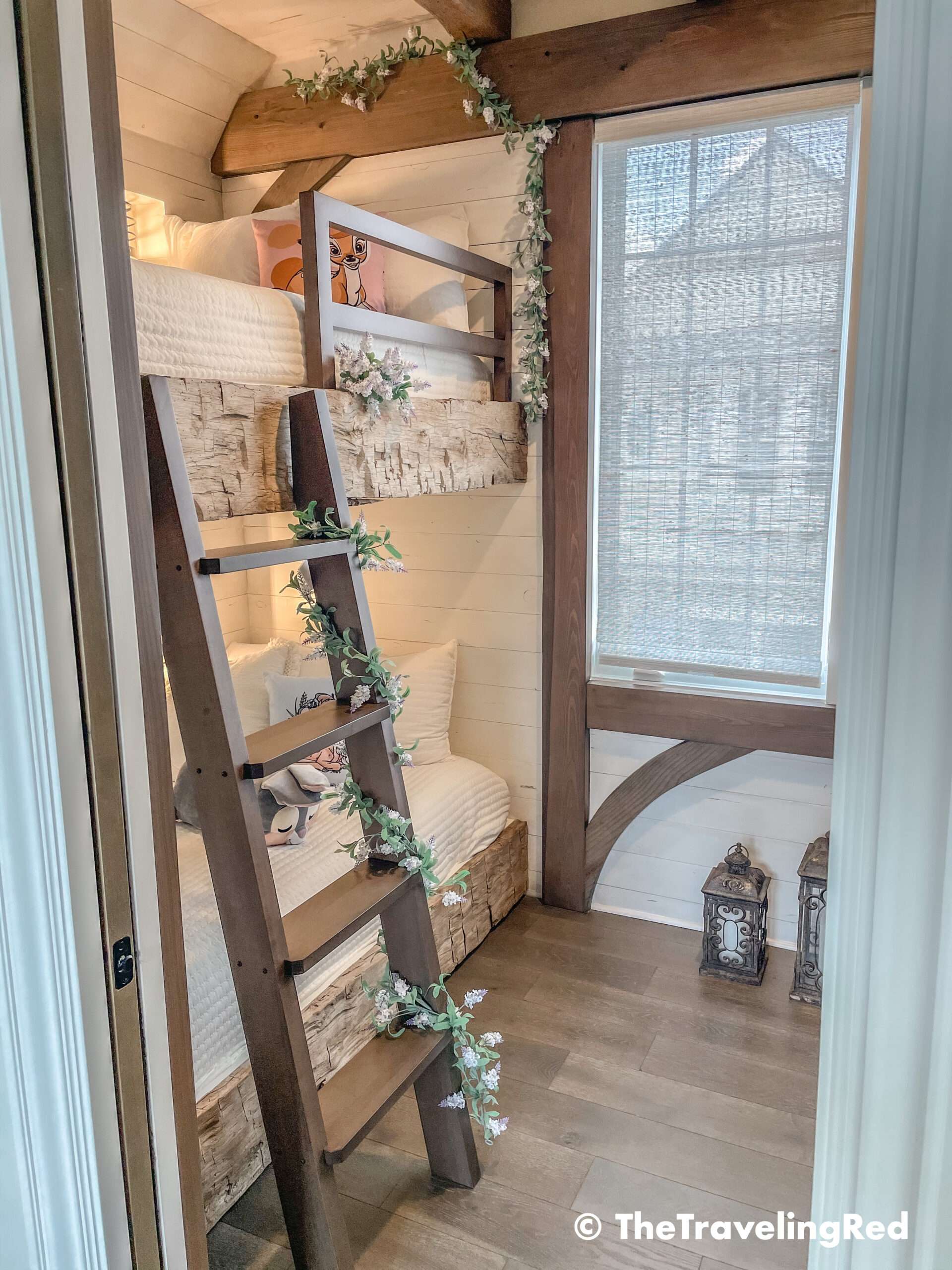 Bambi bunk bed room inside our Disney Golden Oak home. Inspiration for a tiny kids bedroom full of rustic charm and character. Reclaimed wood beams, shiplap, flowers and lanterns fill the room, along with Bambi details.