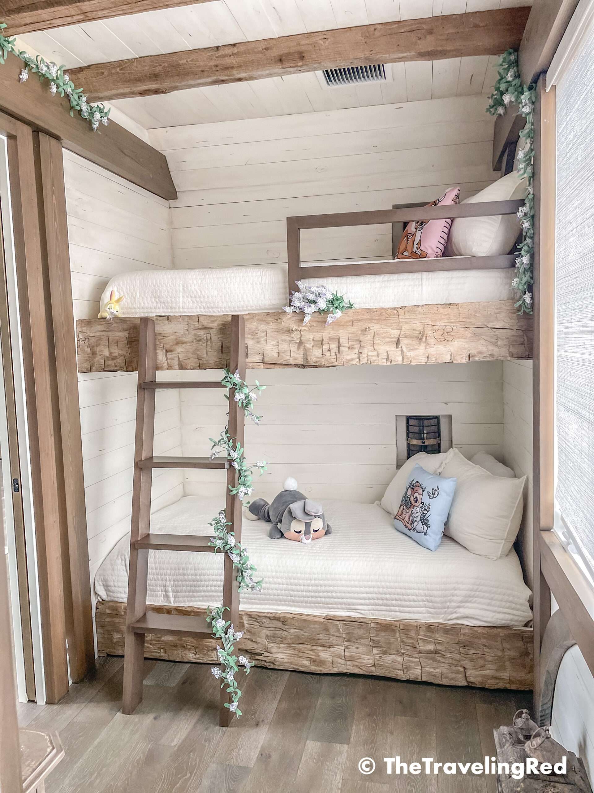 Bambi bunk bed room inside our Disney Golden Oak home. Inspiration for a tiny kids bedroom full of rustic charm and character. Reclaimed wood beams, shiplap, flowers and lanterns fill the room, along with Bambi details.