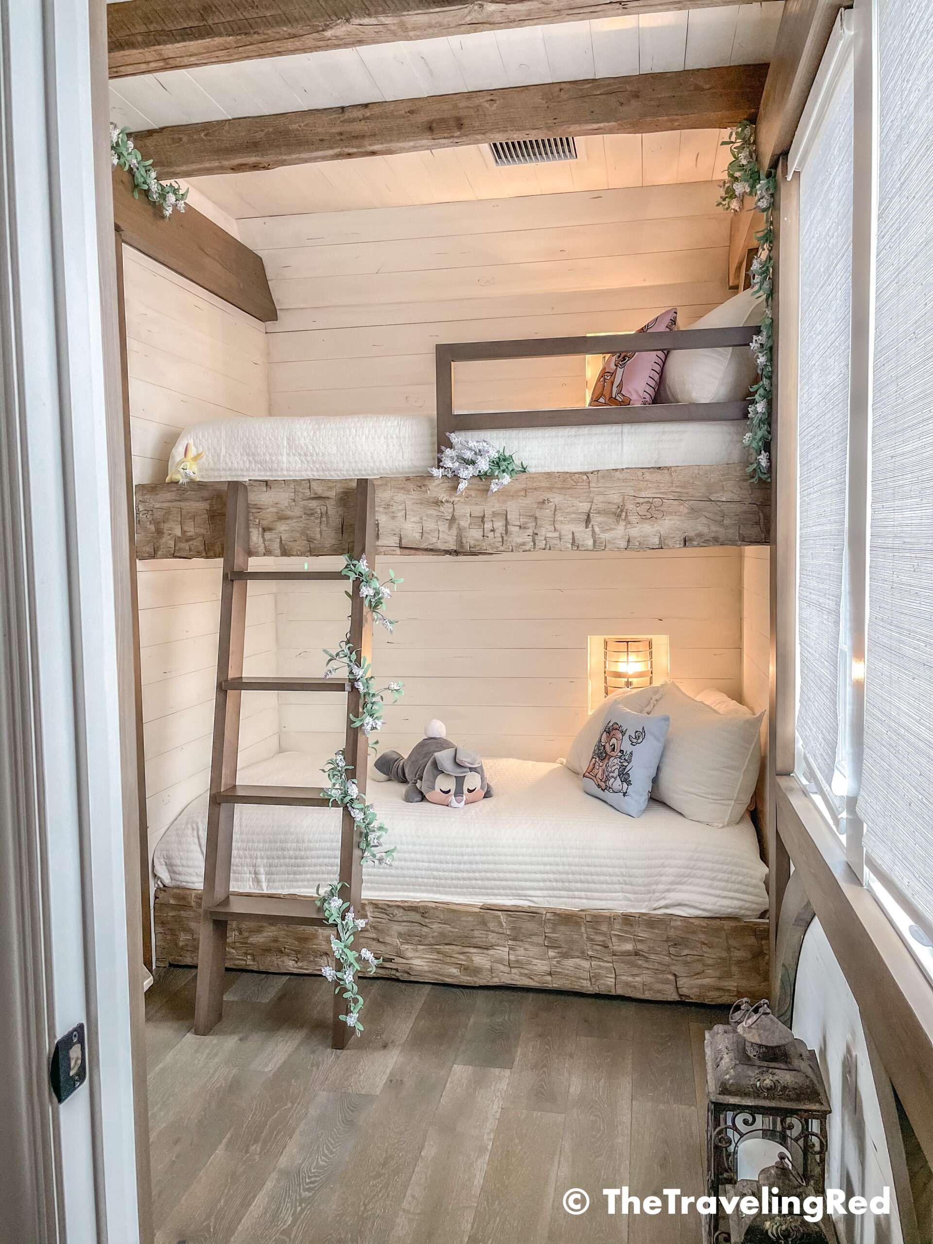 Bambi bunk bed room inside our Disney Golden Oak home. Inspiration for a tiny kids bedroom full of rustic charm and character. Reclaimed wood beams, shiplap, flowers and lanterns fill the room, along with Bambi details.