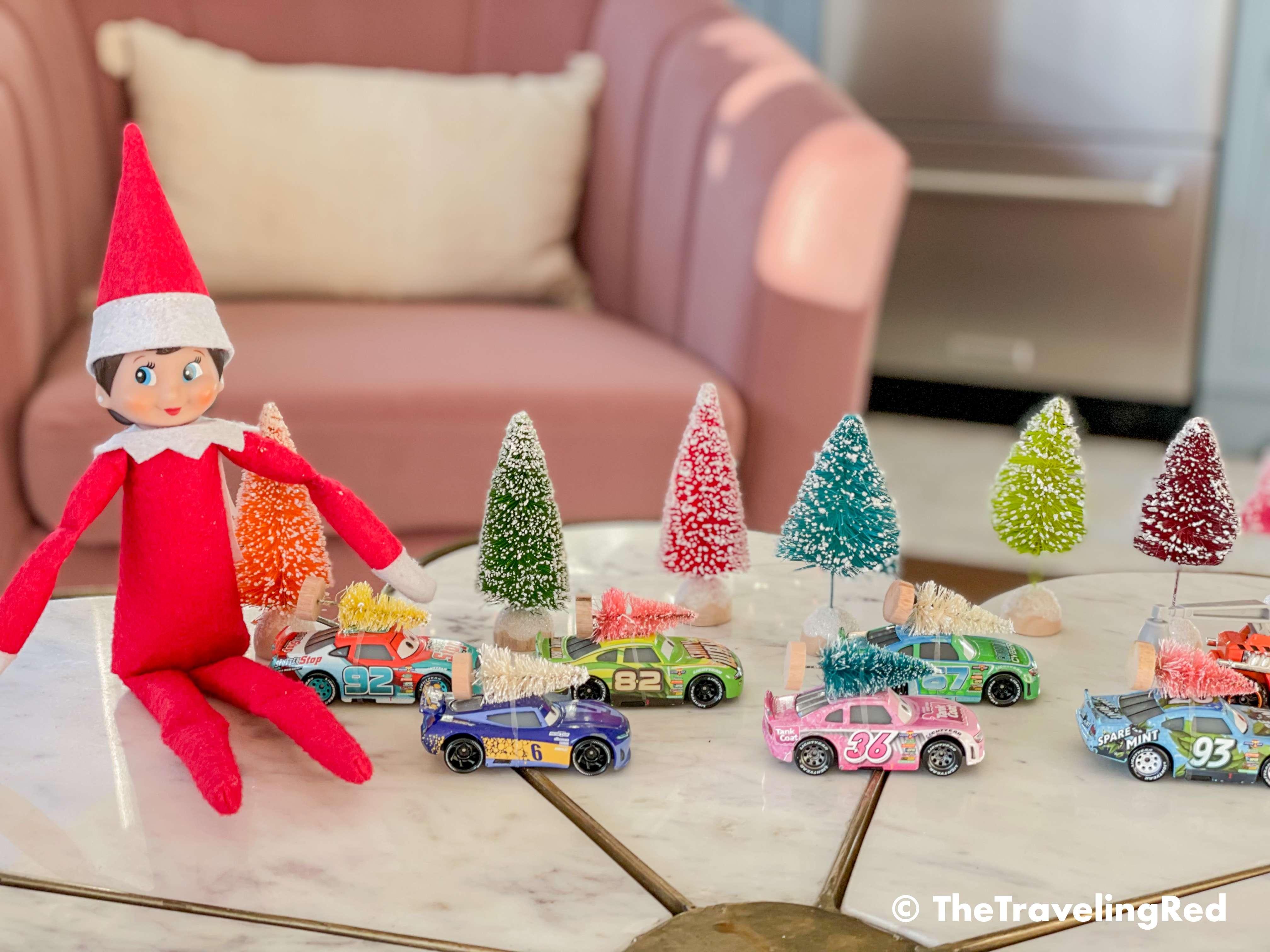 Naughty Elf on the shelf put tiny bottle bruch Christmas trees on all of the toy cars. Fun and easy elf on the shelf ideas for a naughty elf that are quick and easy using things you have at home.