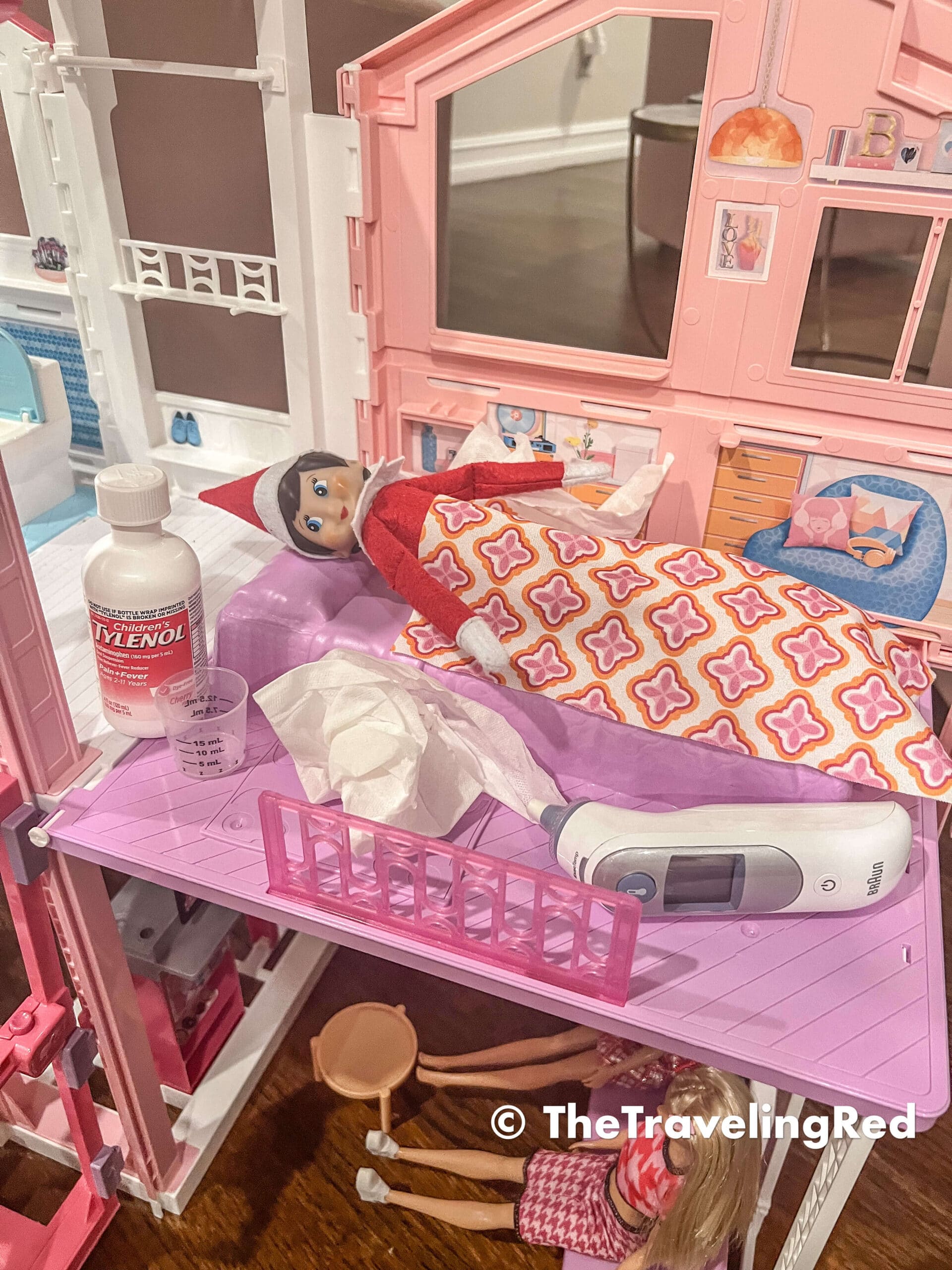 Naughty Elf on the shelf had a sick day. She borrowed a bed in the Barbie house and took the thermometer, some tissues and even the Tylenol. Fun and easy elf on the shelf ideas for a naughty elf that are quick and easy using things you have at home.