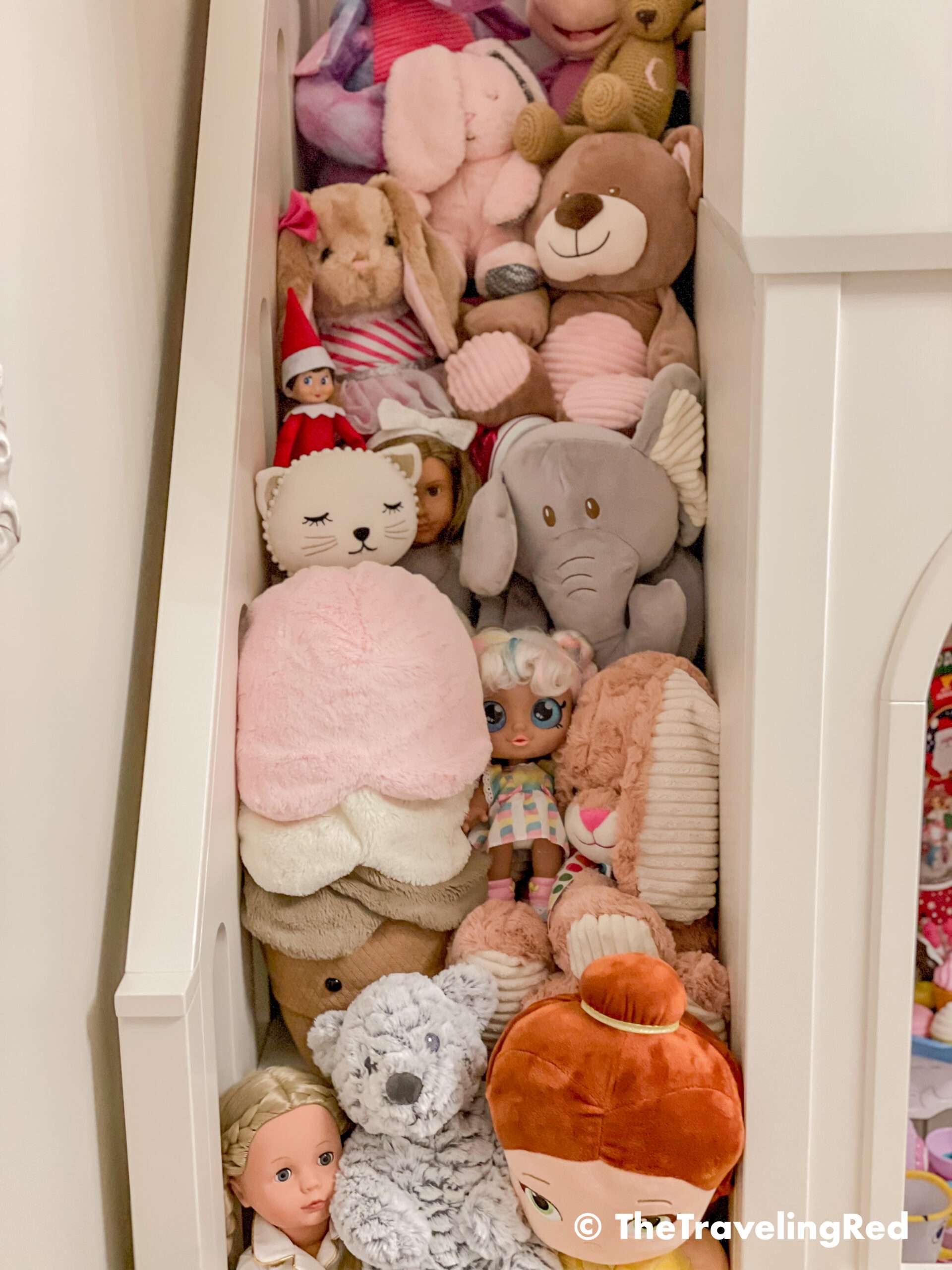 Naughty Elf on the shelf put a lot of toys on the staircase and hung out with them. Fun and easy elf on the shelf ideas for a naughty elf that are quick and easy using things you have at home.
