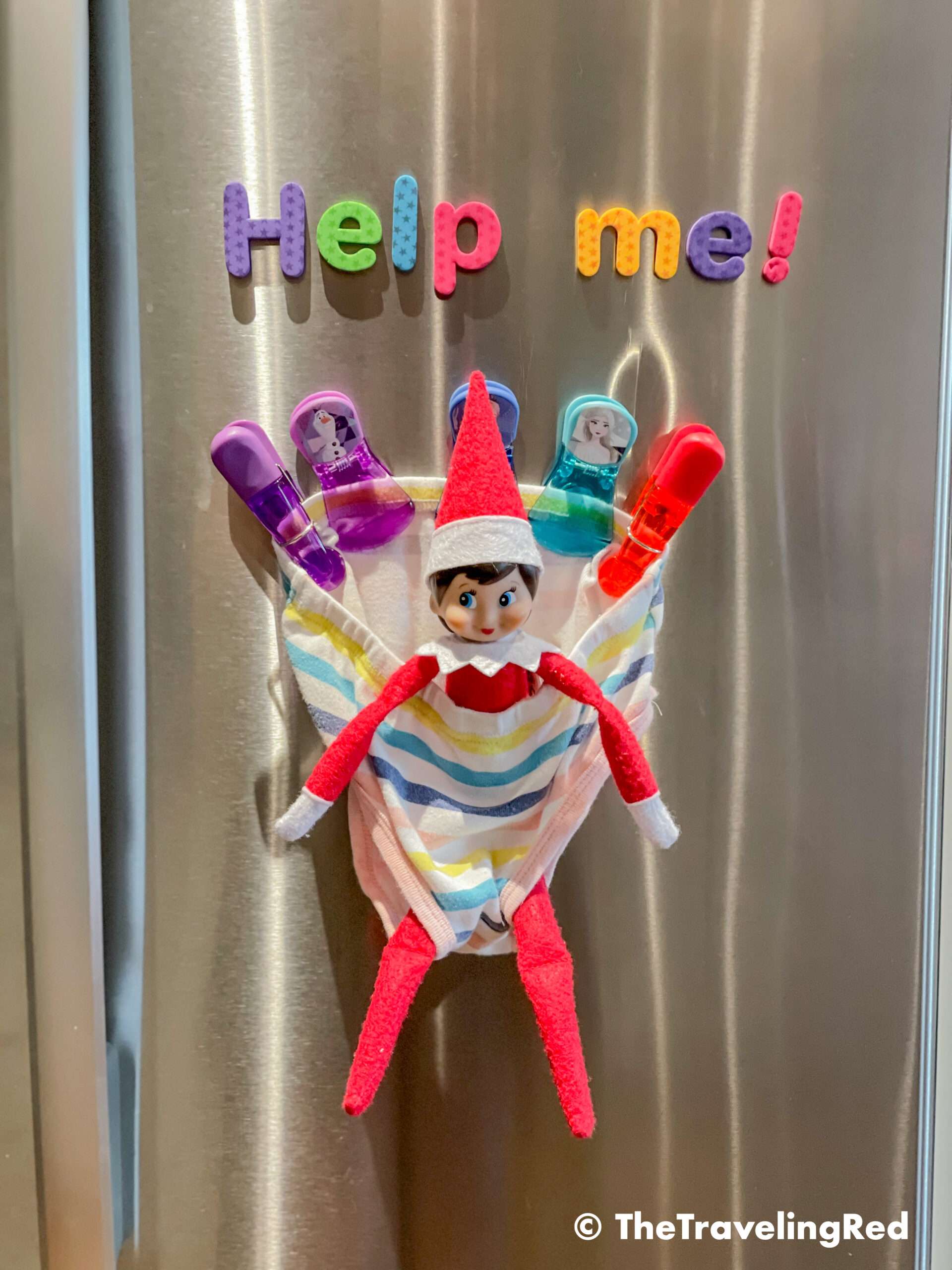 Naughty Elf on the shelf got stuck in an undie on our fridge. All you need is a panty, some magnet clips or tape and possibly a fun message. Fun and easy elf on the shelf ideas for a naughty elf that are quick and easy using things you have at home.