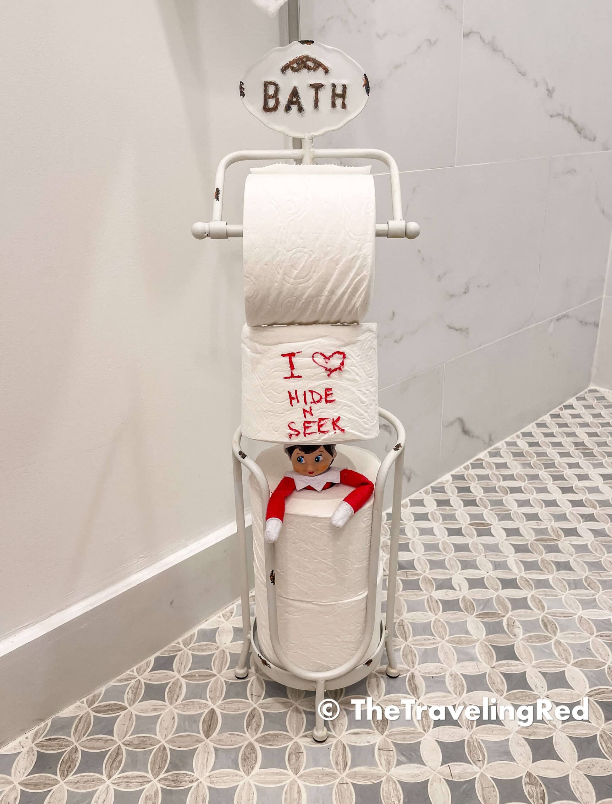 Naughty Elf on the shelf playing hide and seek in the toilet paper rolls. Fun and easy elf on the shelf ideas for a naughty elf that are quick and easy using things you have at home.