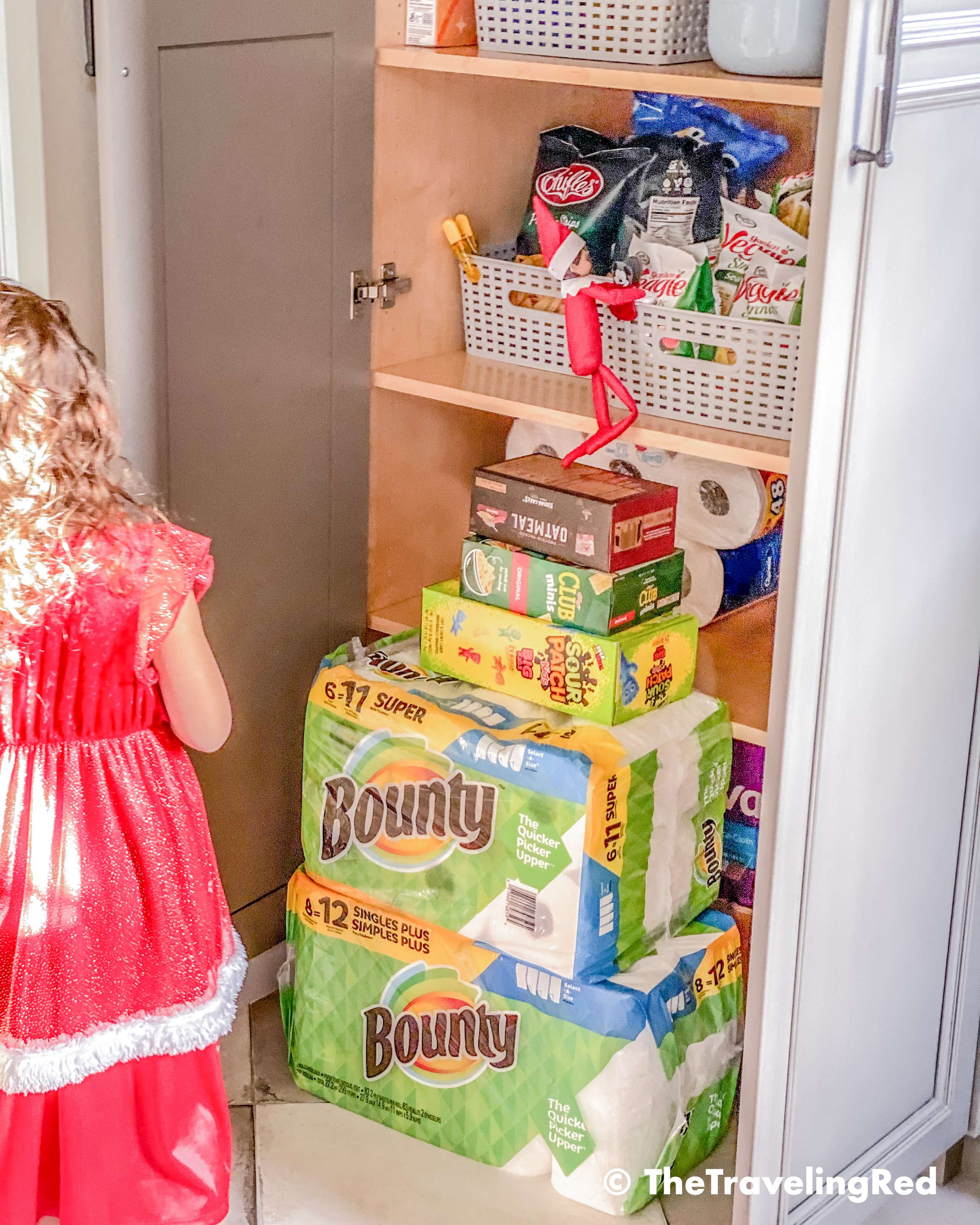 Naughty Elf on the shelf used household items to climb into the pantry to steal snacks. Fun and easy elf on the shelf ideas for a naughty elf that are quick and easy using things you have at home.