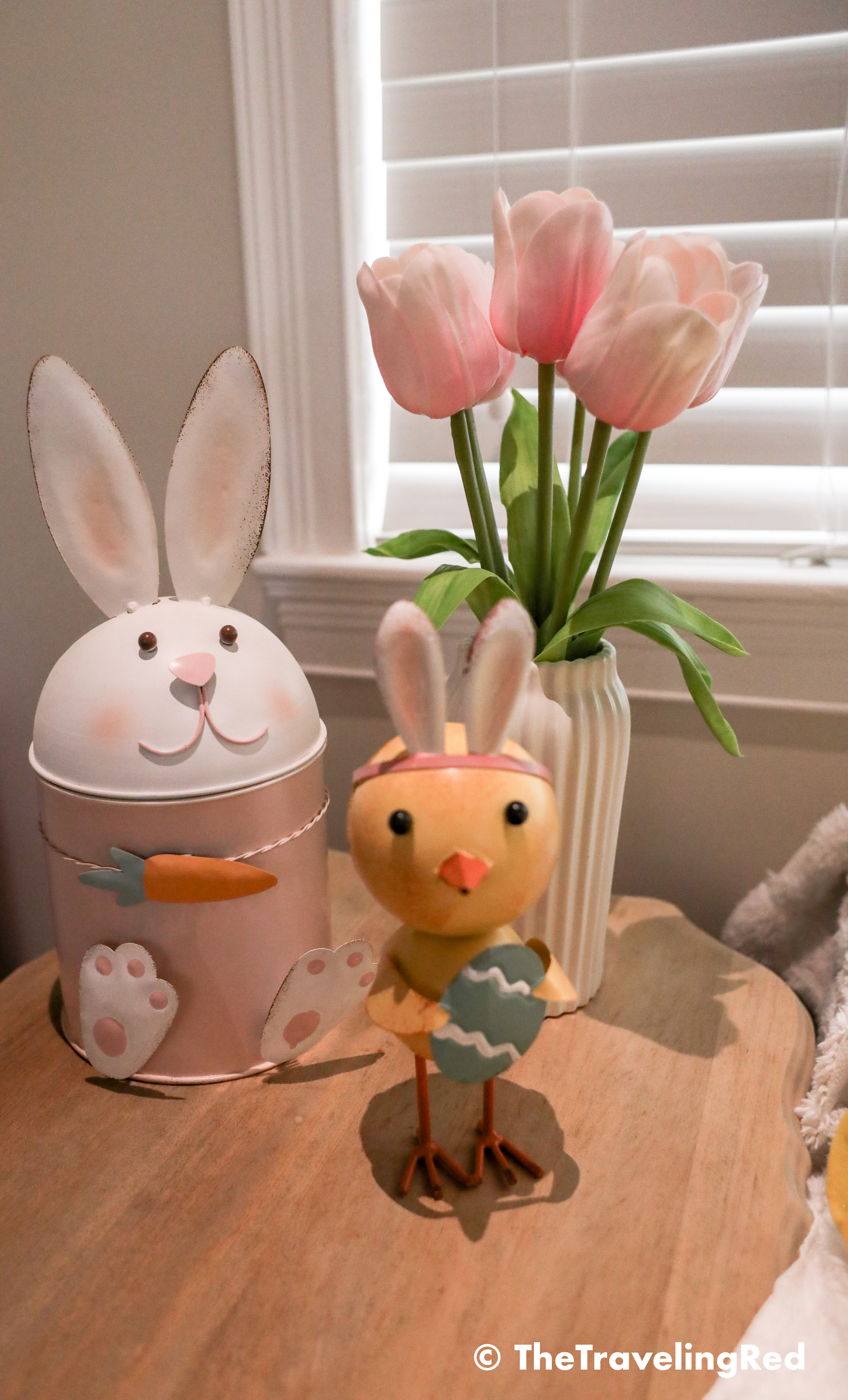 Living room easter decor. Added a bunny and chick to my side table with some tulips and a candle as my spring and easter decor.