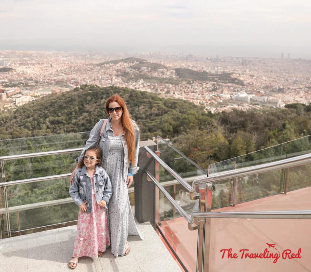 View from Tibidabo Amusement Park overlooking the city of Barcelona, Spain. One of the best views in the whole city. Here's our full 7 day barcelona itinerary. Everything you need to know for one week in Barcelona, Spain. By The Traveling Red