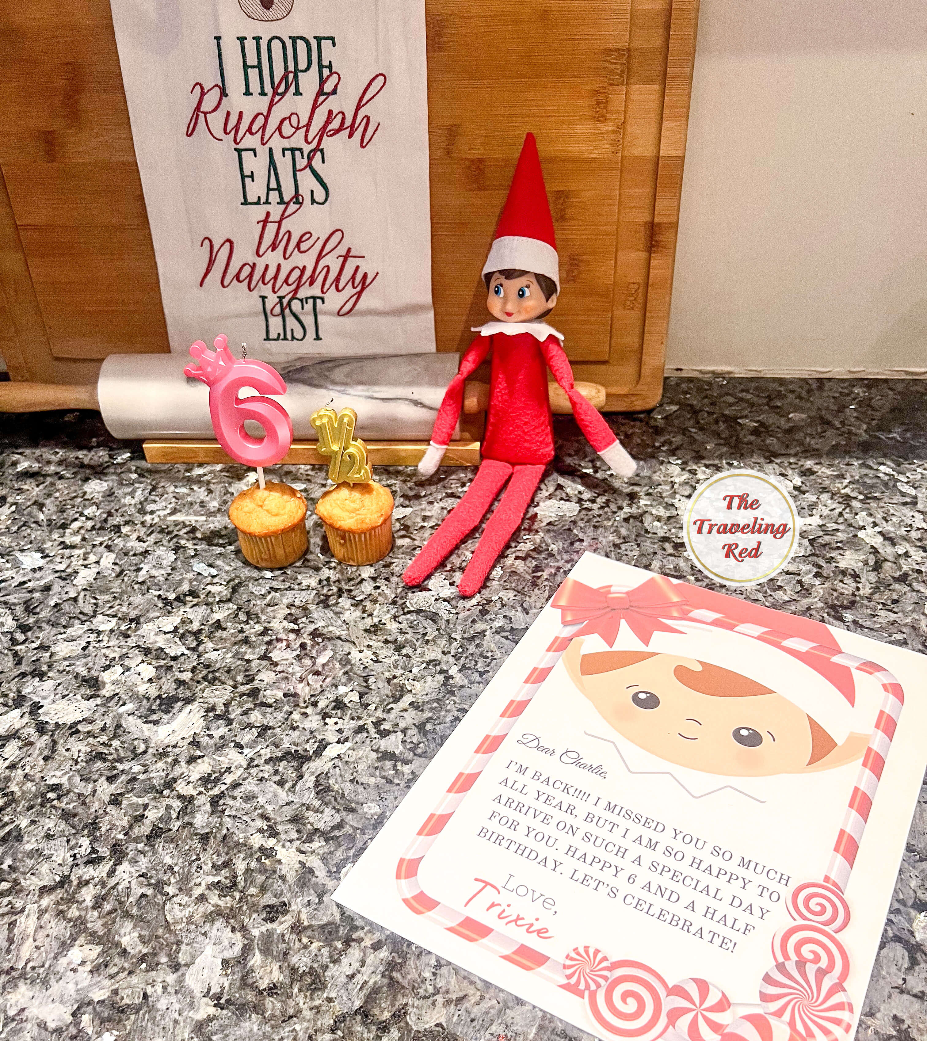 Elf on the Shelf Ideas: Elf brought a cupcake to celebrate her half birthday and decorated with a banner and candles. Over 100 easy and quick elf on the shelf ideas that are fun. By The Traveling Red