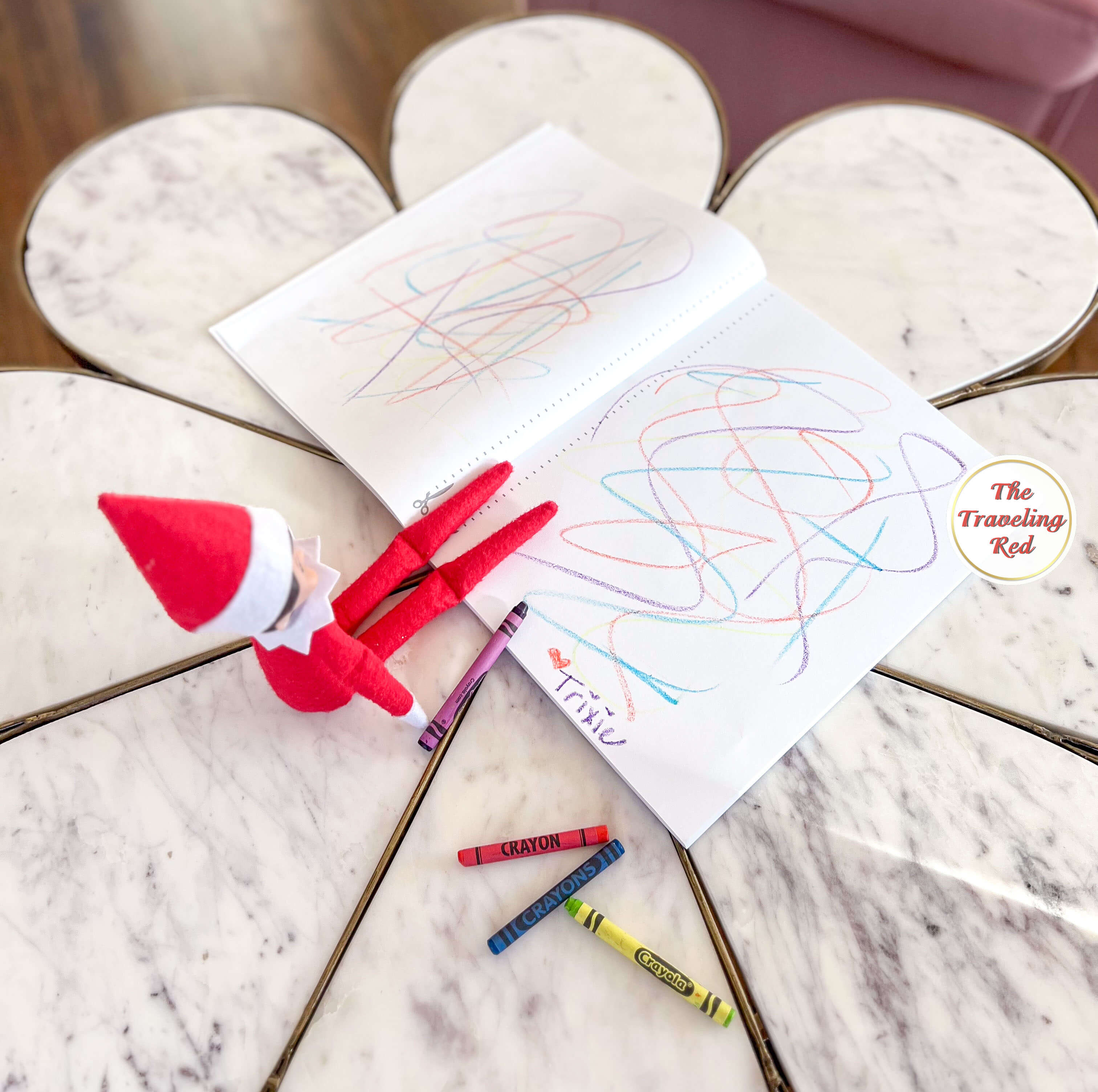 Elf on the Shelf Ideas: Elf colored a new sketchpad making a messy drawing by the elf. Over 100 easy and quick elf on the shelf ideas that are fun. By The Traveling Red