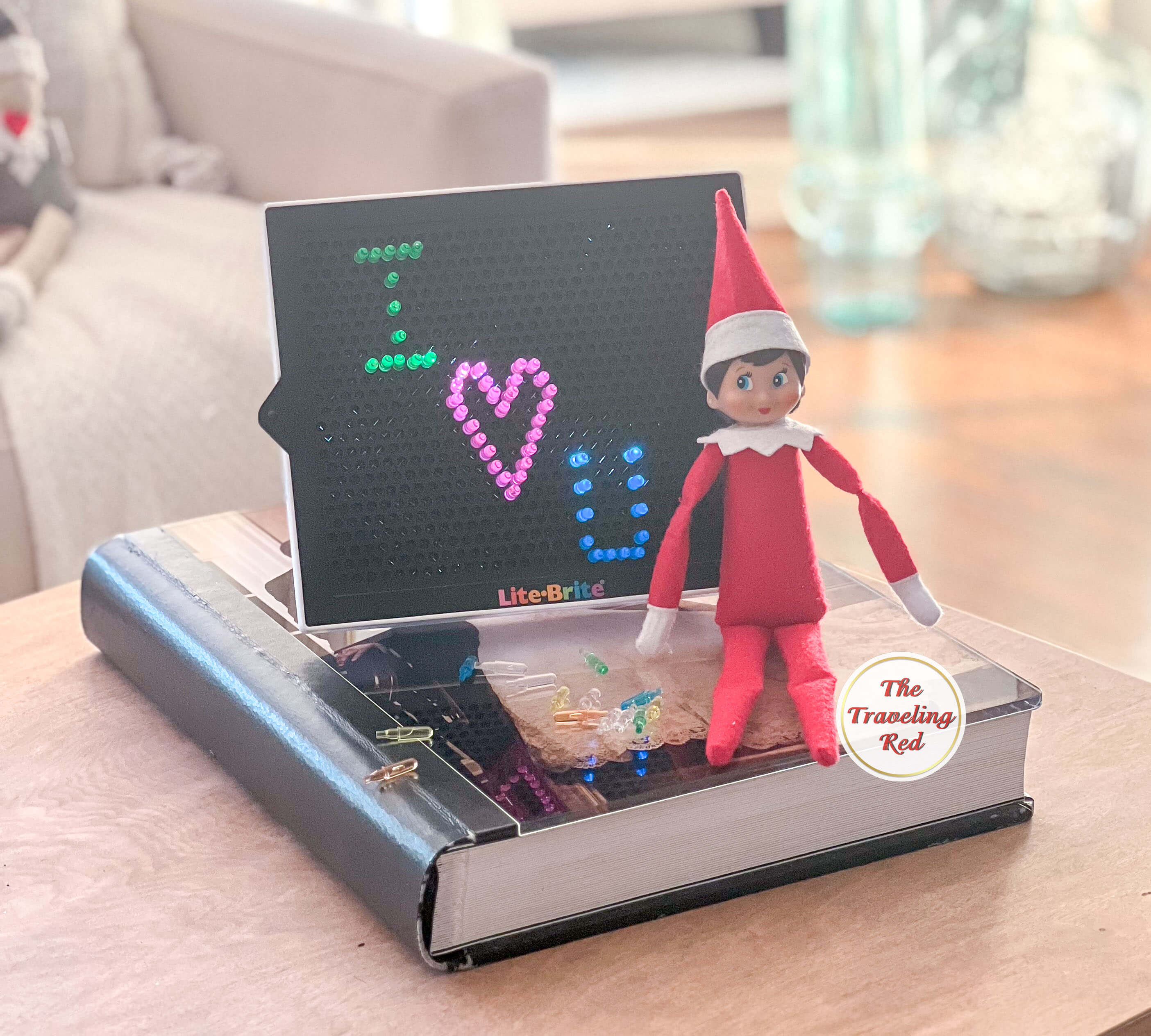 Elf on the Shelf Ideas: Elf used the lite brite to write I love you. Over 100 easy and quick elf on the shelf ideas that are fun. By The Traveling Red
