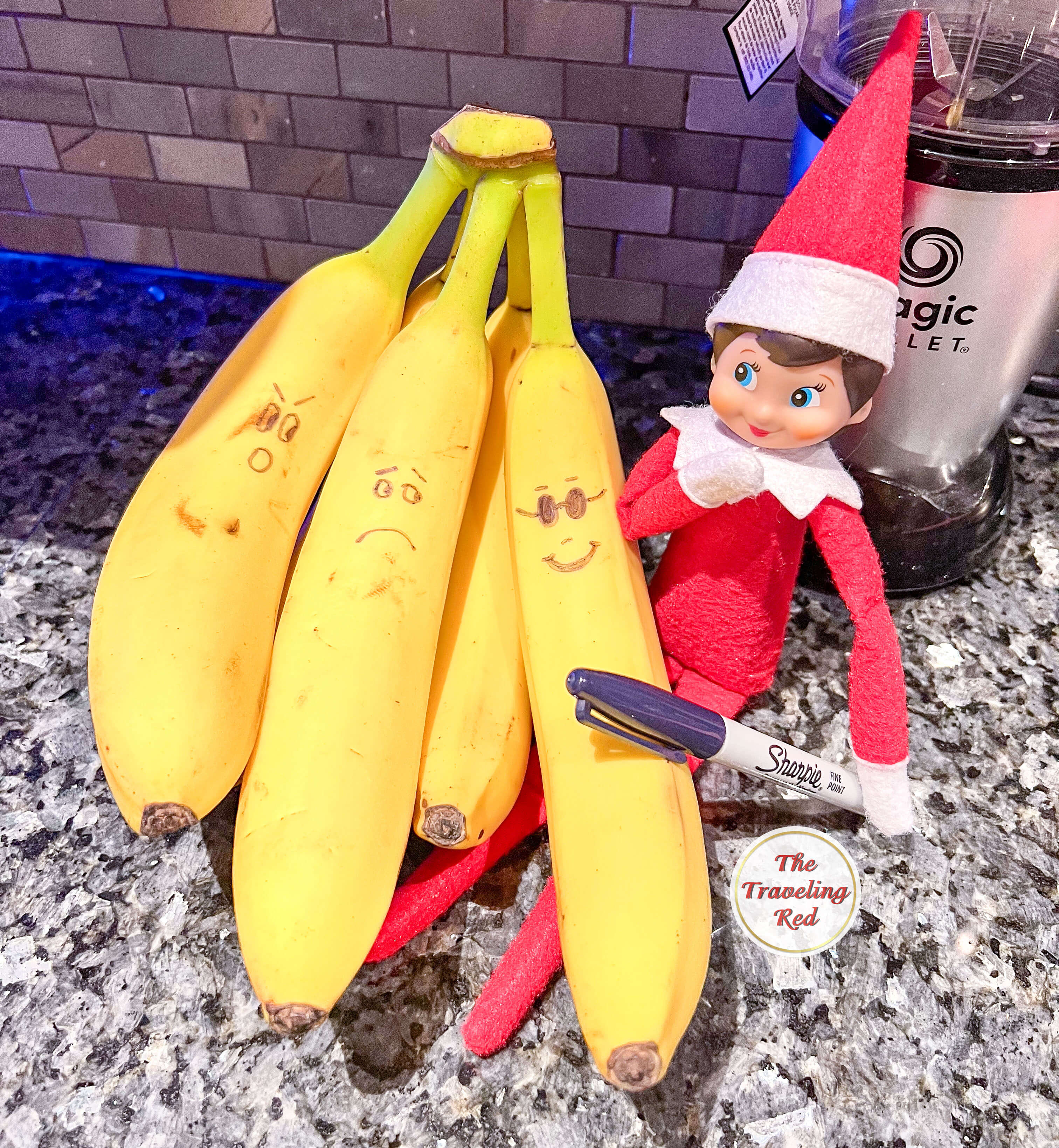 Elf on the Shelf Ideas: Elf drew funny faces on the bananas using a sharpie. Over 100 easy and quick elf on the shelf ideas that are fun. By The Traveling Red