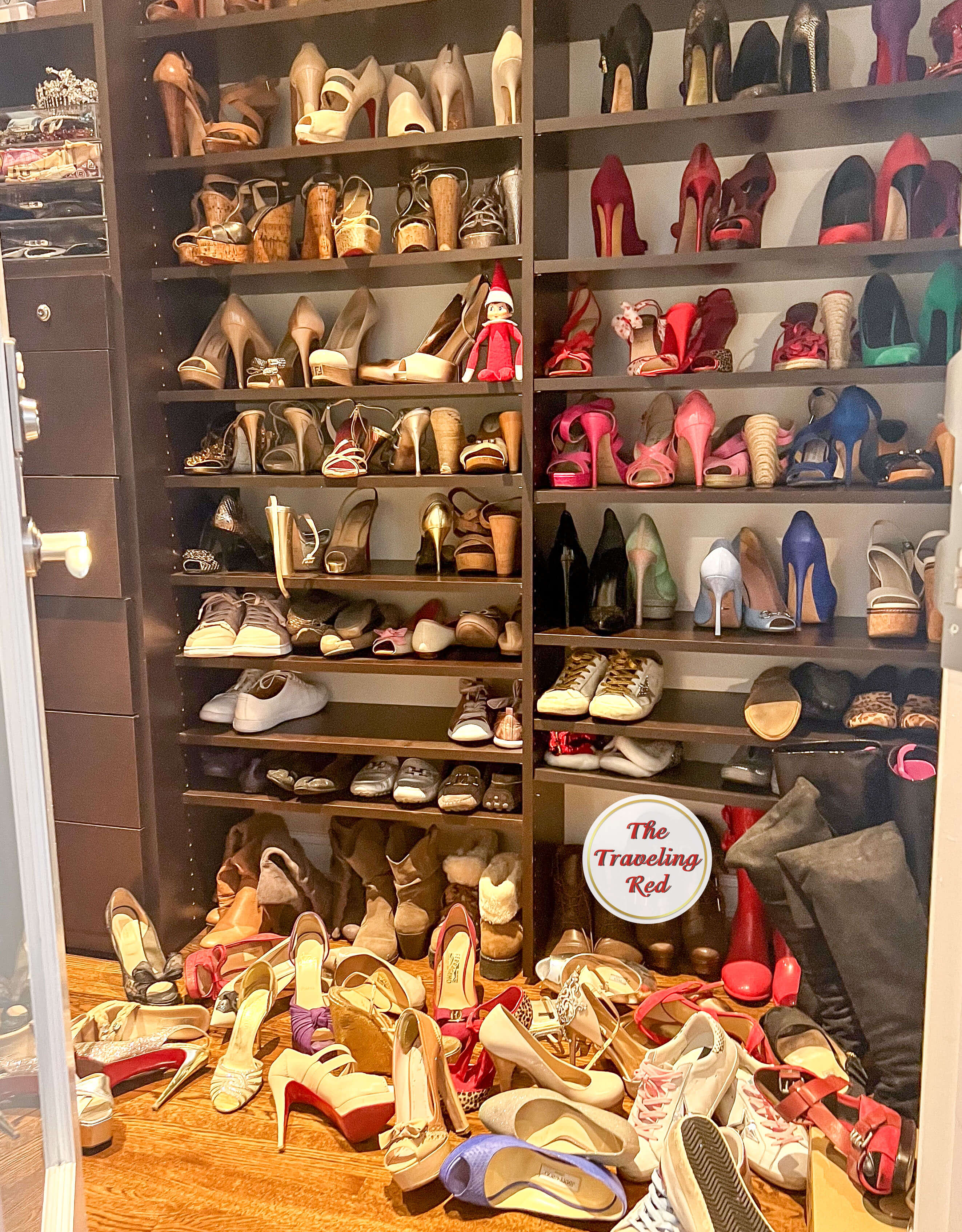 Elf on the Shelf Ideas: Elf made a mess in mommy's closet and threw her shoes on the floor. Elf is sitting on the shelf. Over 100 easy and quick elf on the shelf ideas that are fun. By The Traveling Red