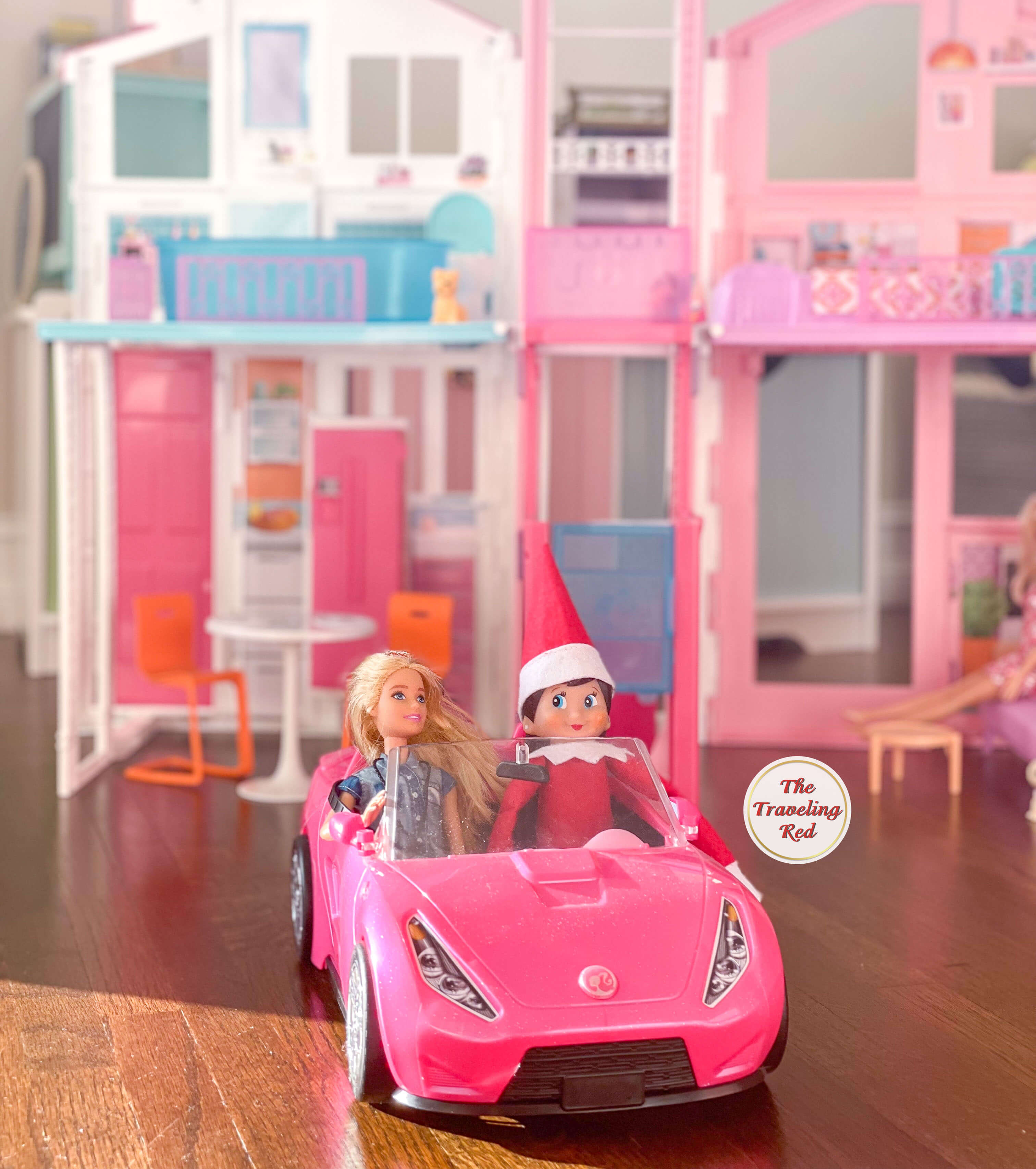 Elf on the Shelf Ideas: Elf is out for a drive with barbie in a barbie car. Over 100 easy and quick elf on the shelf ideas that are fun. By The Traveling Red
