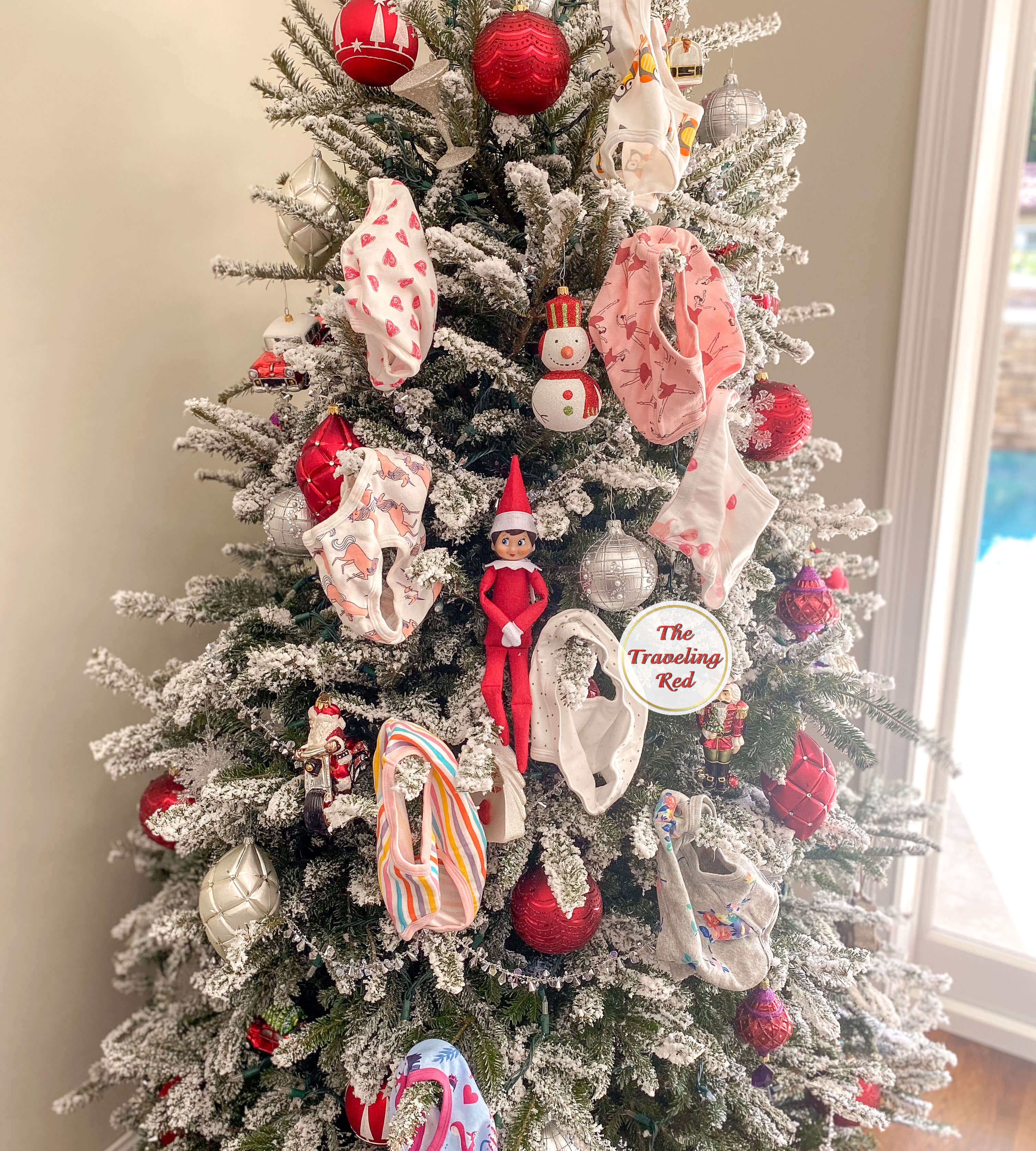 Elf on the Shelf Ideas: Elf hung underwear on the tree as ornaments and the elf is in the tree. Over 100 easy and quick elf on the shelf ideas that are fun. By The Traveling Red