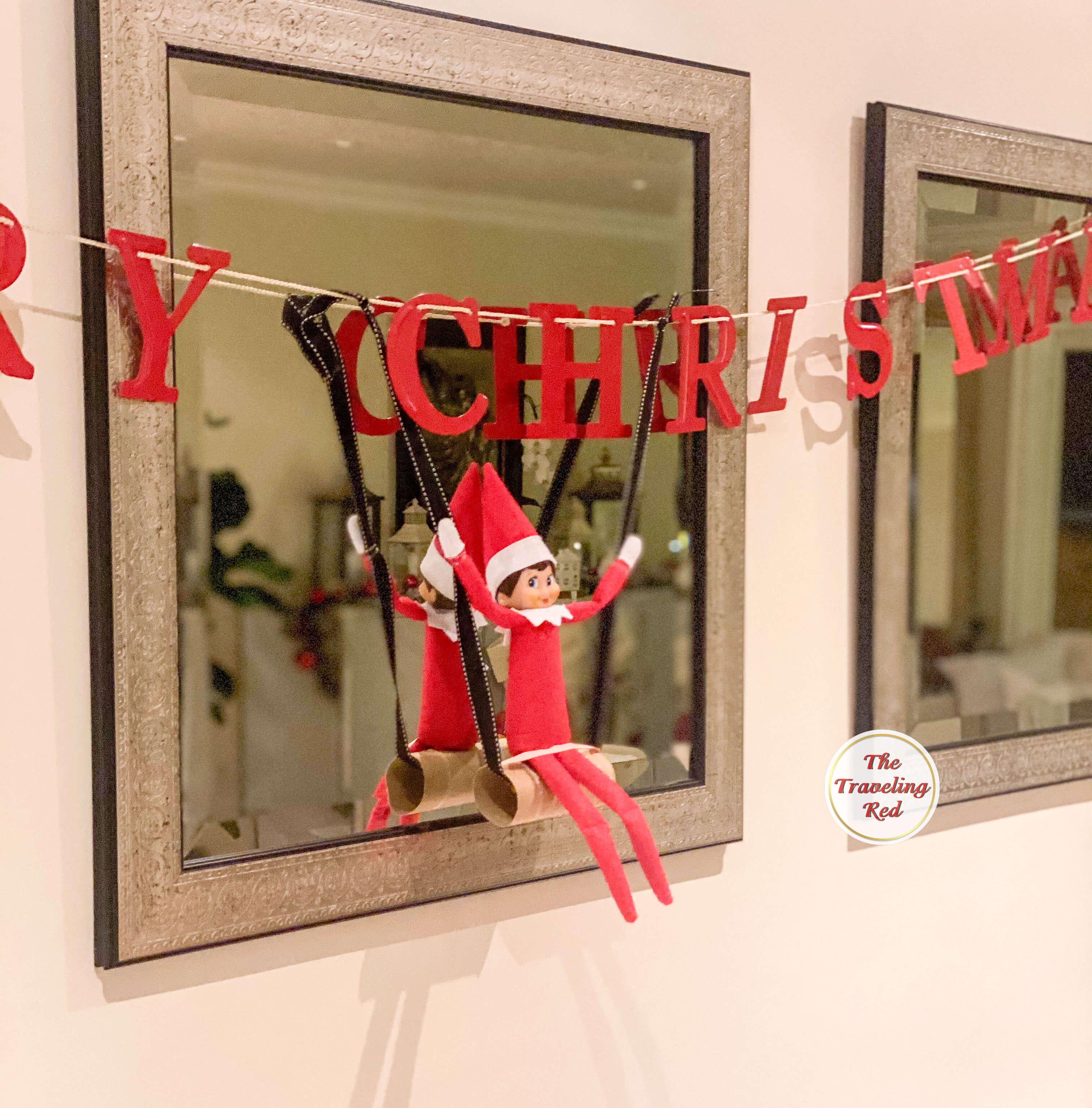 Elf on the Shelf Ideas: Elf is swinging on a toilet paper roll. Over 100 easy and quick elf on the shelf ideas that are fun. By The Traveling Red