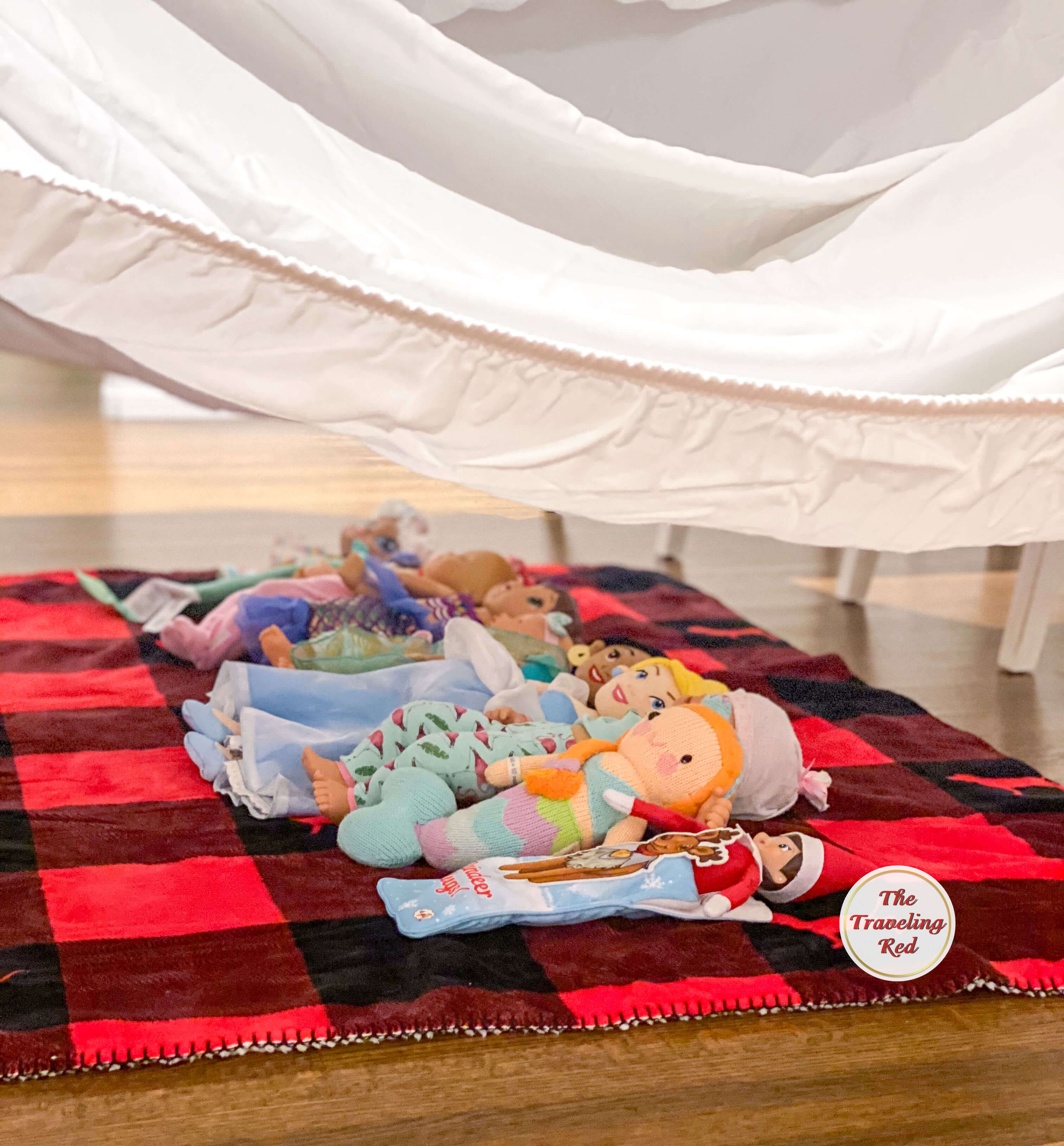 Elf on the Shelf Ideas: Elf built a fort and had a slumber party with a bunch of friends (dolls and stuffed animals). Over 100 easy and quick elf on the shelf ideas that are fun. By The Traveling Red