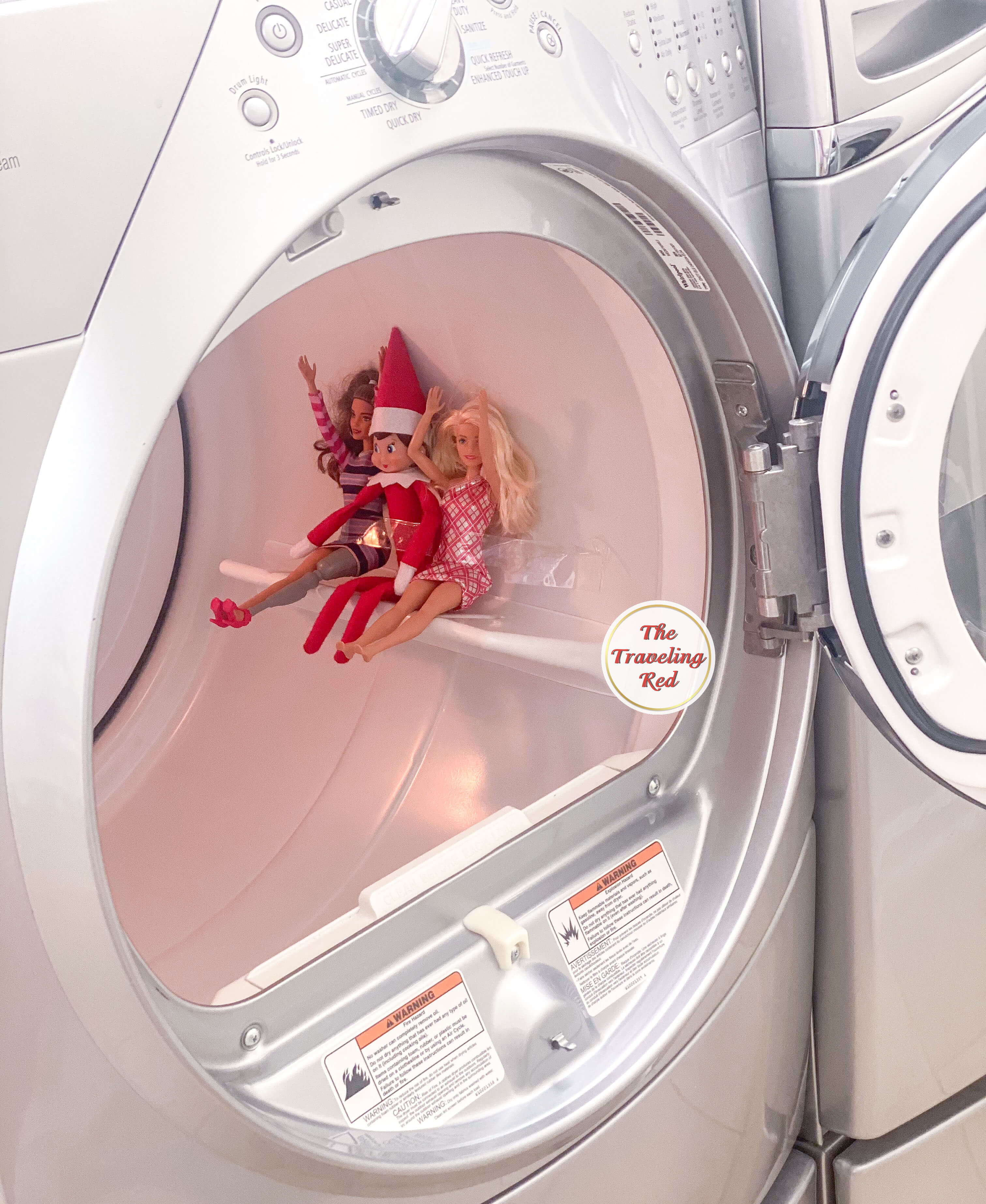 Elf on the Shelf Ideas: Elf brought 2 barbie friends along and they got taped into our dryer like a carnival ride. Over 100 easy and quick elf on the shelf ideas that are fun. By The Traveling Red