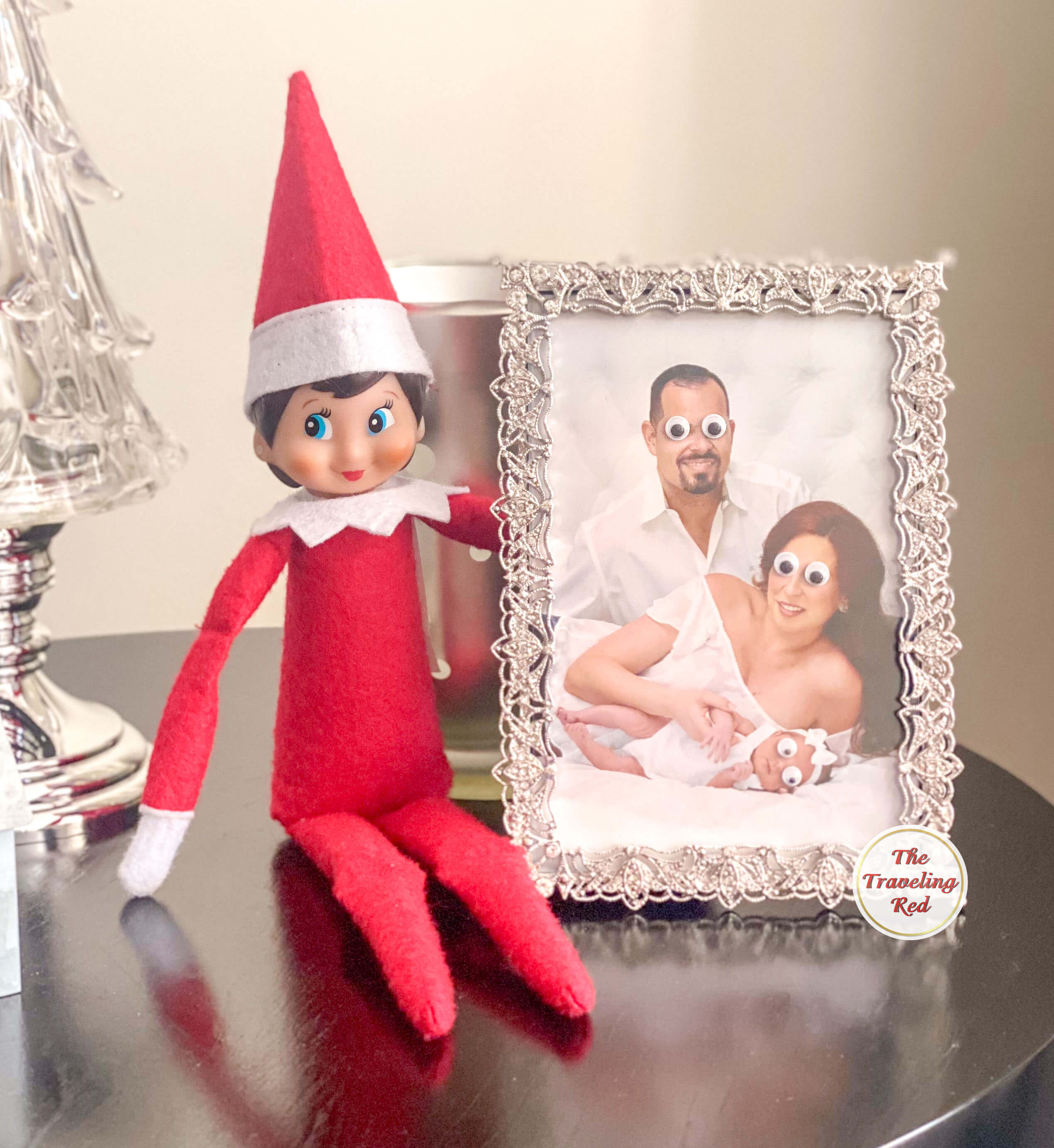 Elf on the Shelf Ideas: Elf put googly eyes on our family photo. Over 100 easy and quick elf on the shelf ideas that are fun. By The Traveling Red