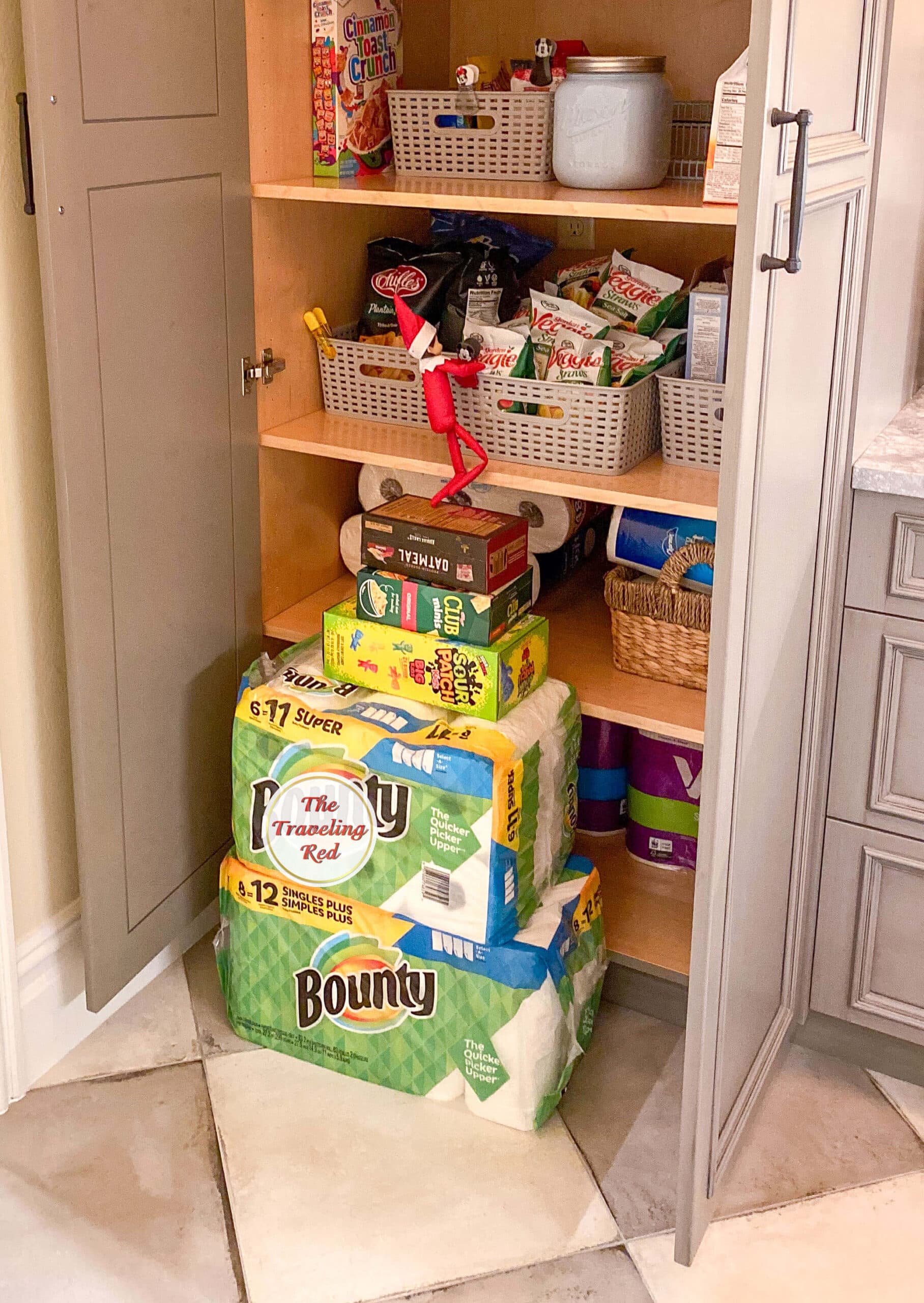 Elf on the Shelf Ideas: Elf used house supplies stacked to climb into the pantry to grab a snack. Over 100 easy and quick elf on the shelf ideas that are fun. By The Traveling Red